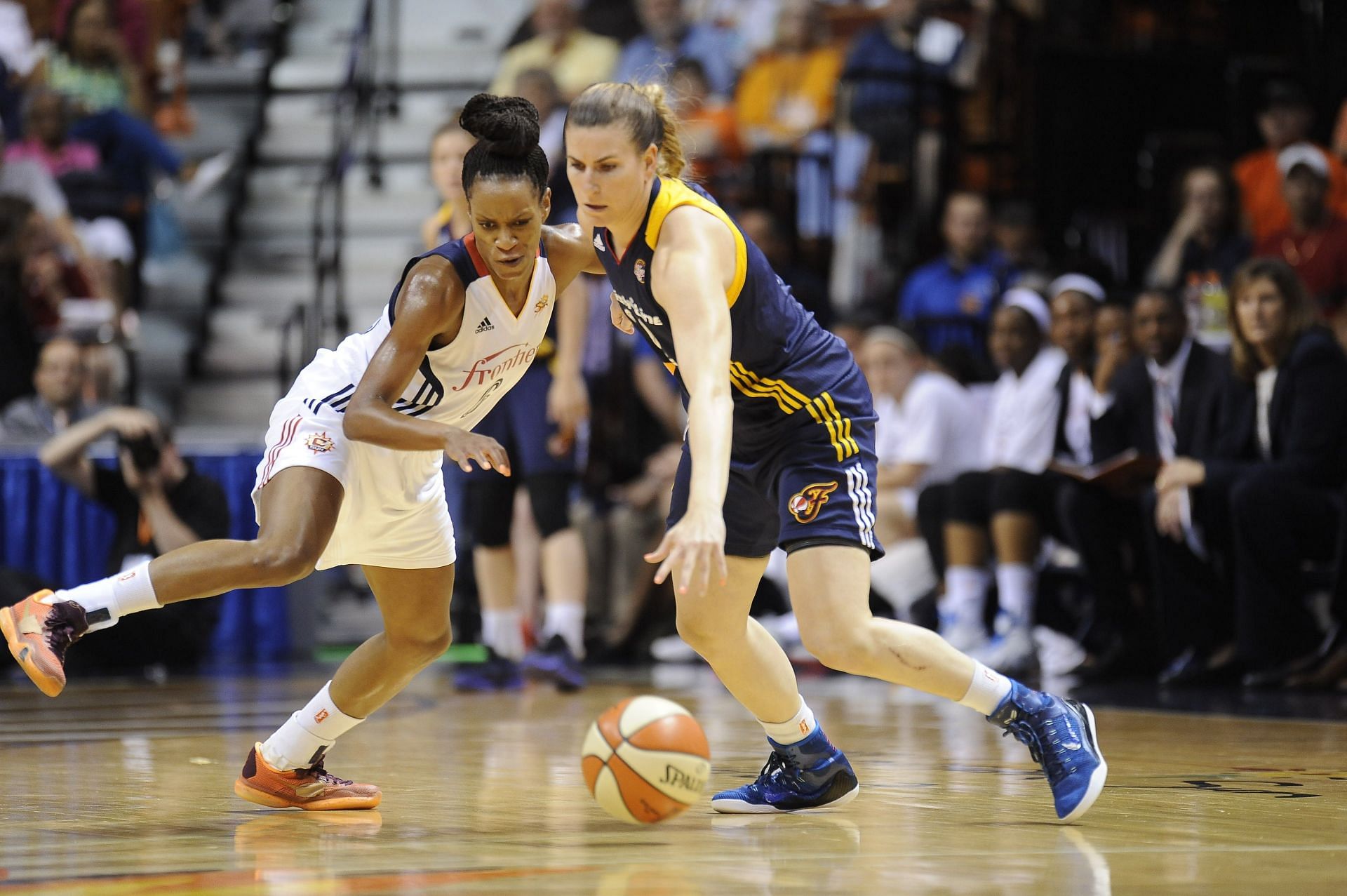 Connecticut Sun Guard Jasmine Thomas (6) and Indiana Fever Guard Jeanette Pohlen (32) battle for the ball. (Credits: Getty)