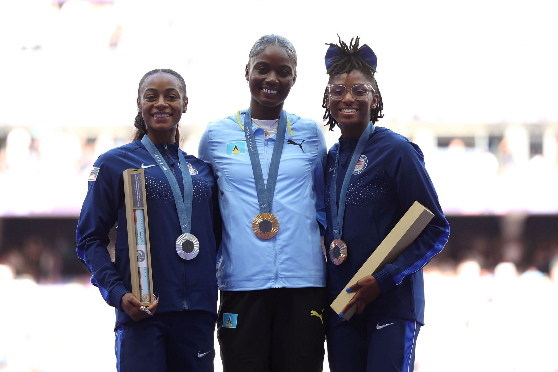 Sha&#039;Carri Richardson (L) , Julien Alfred (C)and Melissa Jefferson (R) with their medals at the Paris Olympics 2024 (Photo by Alex Pantling/Getty Images)