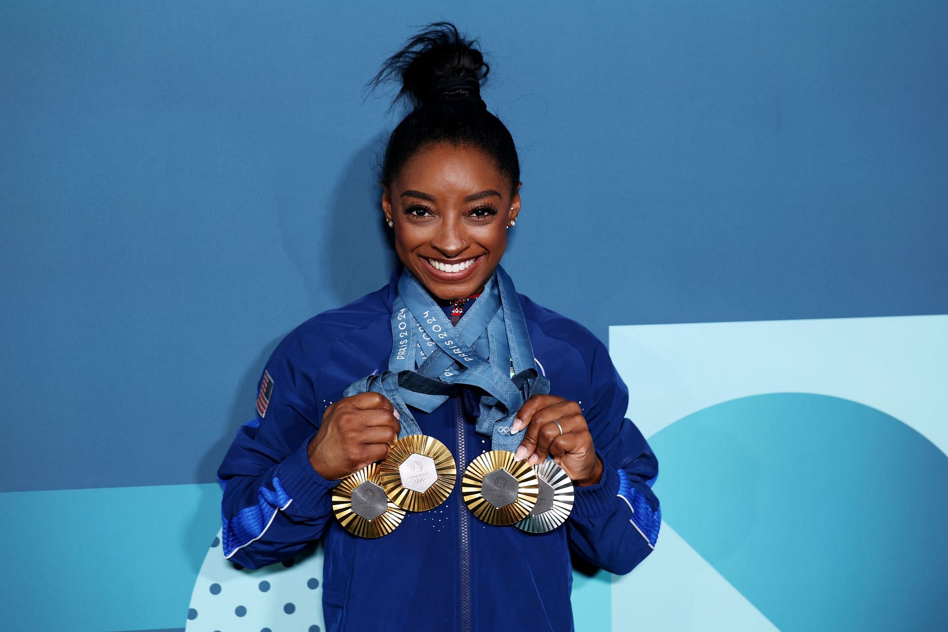 Simone Biles of Team United States poses with her Paris 2024 Olympic medals. (Photo by Getty Images)