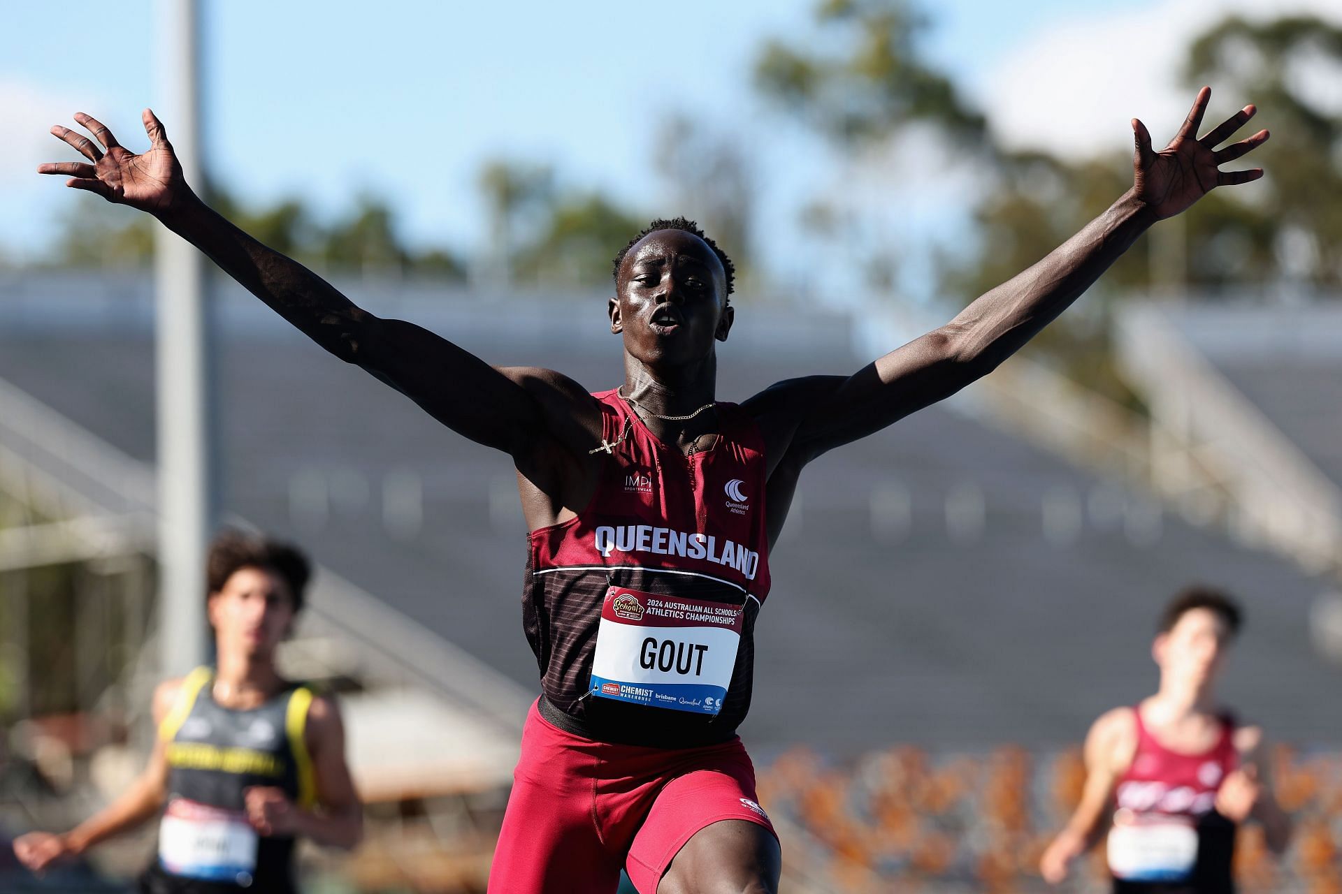 Gout celebrating after his victory in the U18 100m final in the 2024 All Schools Athletics Championship (Image via: Getty Images)