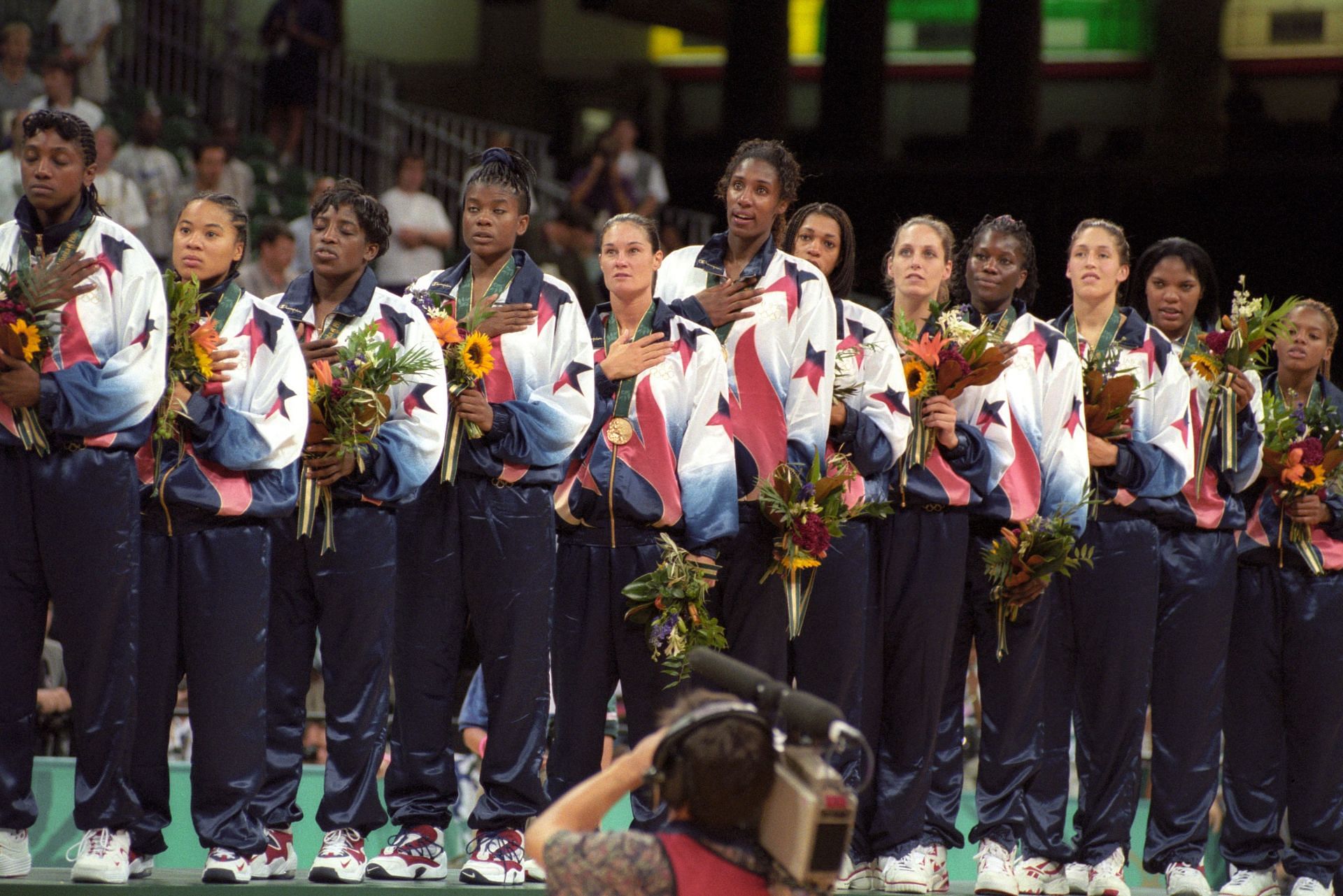 Dawn Staley, Sheryl Swoopes and the rest of Team USA team sing the national anthem after winning the gold medal in women&#039;s basketball at the 1996 Atlanta Olympics. (Photo: Getty)