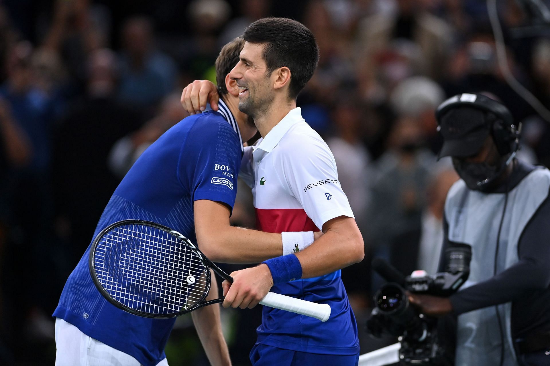 Novak Djokovic (R) shakes hands at the net with Daniil Medvedev at the Paris Masters. Source: Getty