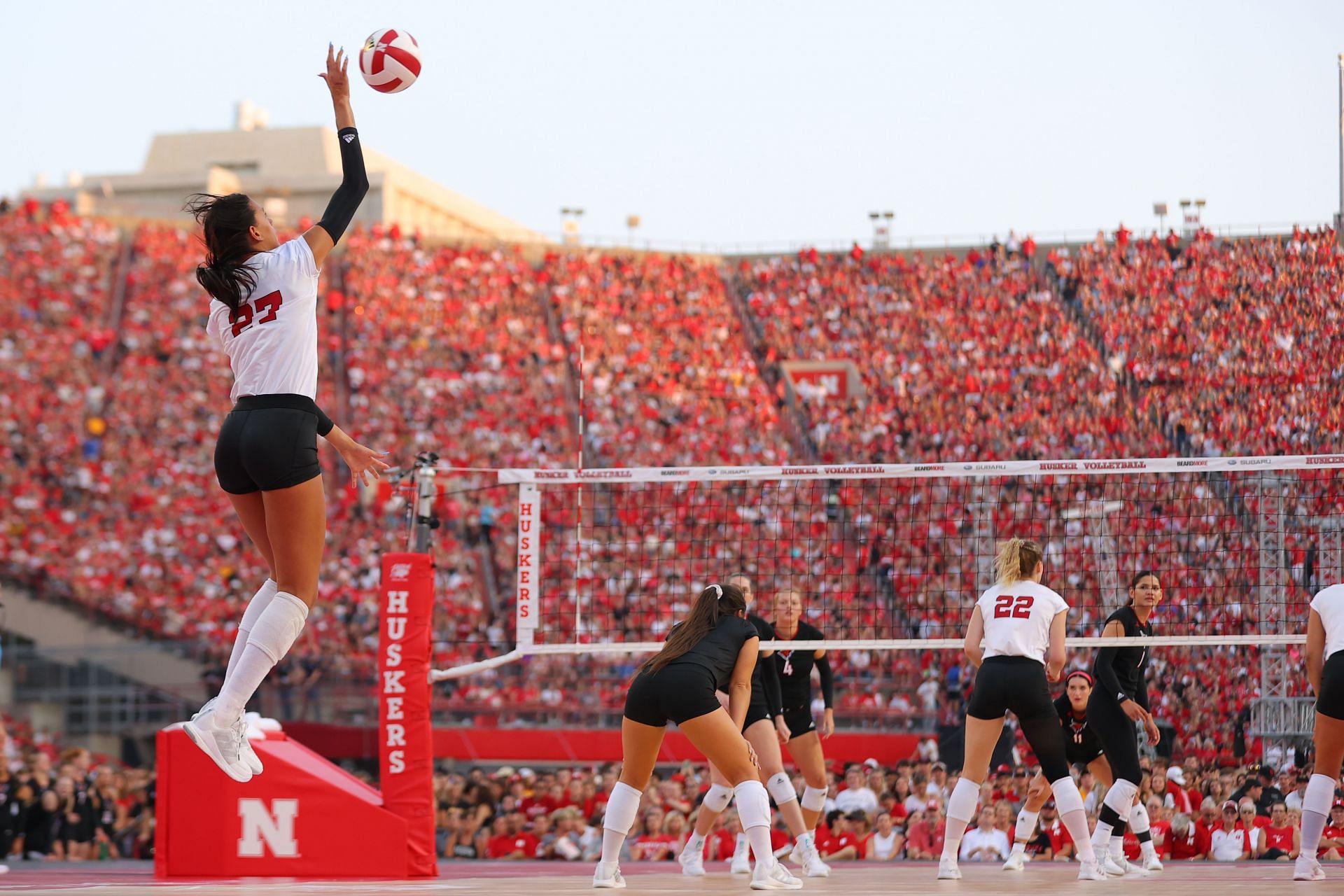 Harper Murray smashing the ball wearing jersey no.27 during a match against Omaha Mavericks in the NCAA Championships (Image via: Getty Images)