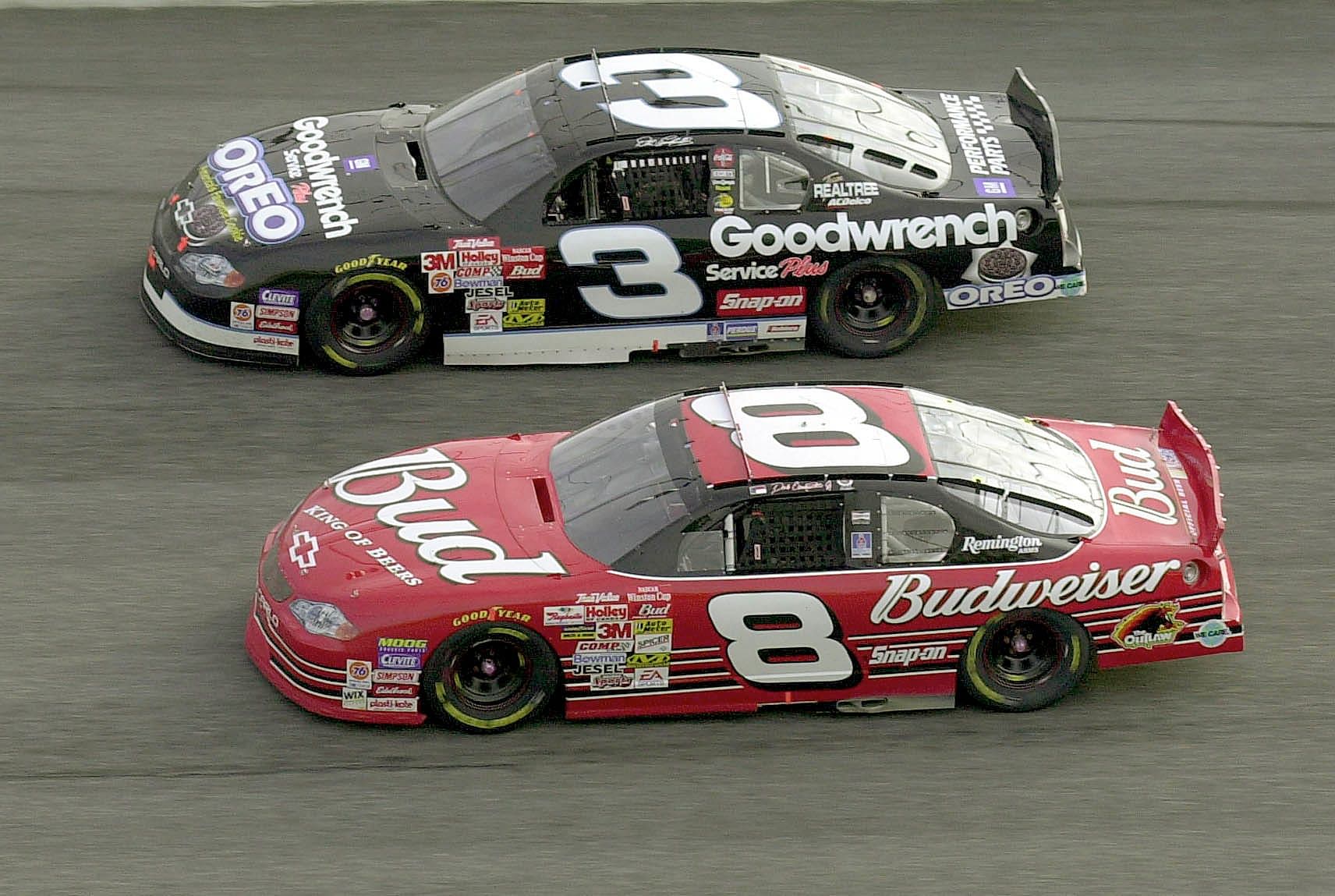 Dale Earnhardt, background, and his son, Dale Earnhardt Jr., run side by side in turn 2 during the Budweiser Shootout at Daytona International Speedway, Sunday.