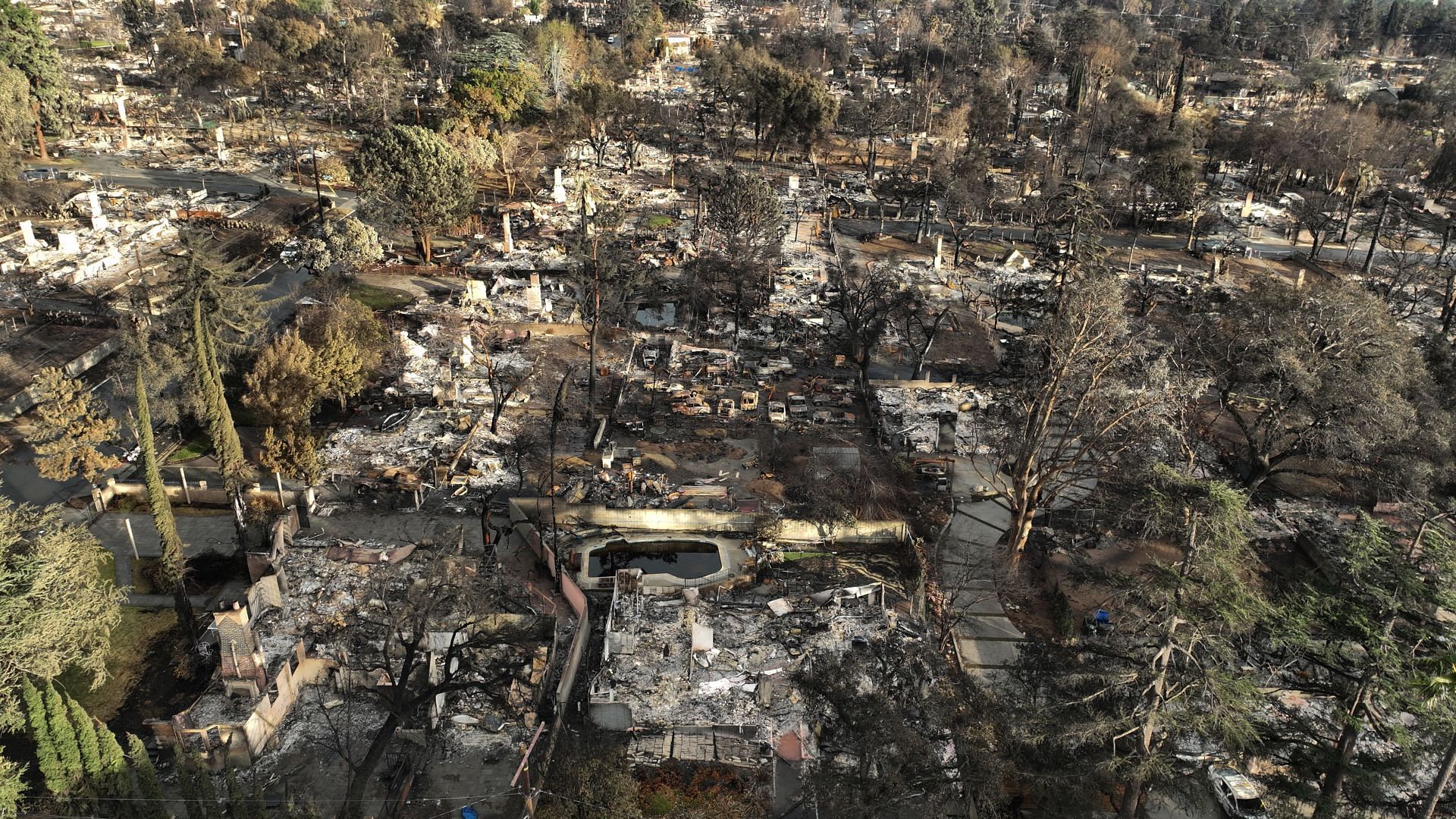 Eaton fire damaged homes and businesses in the rain. - Source: Getty