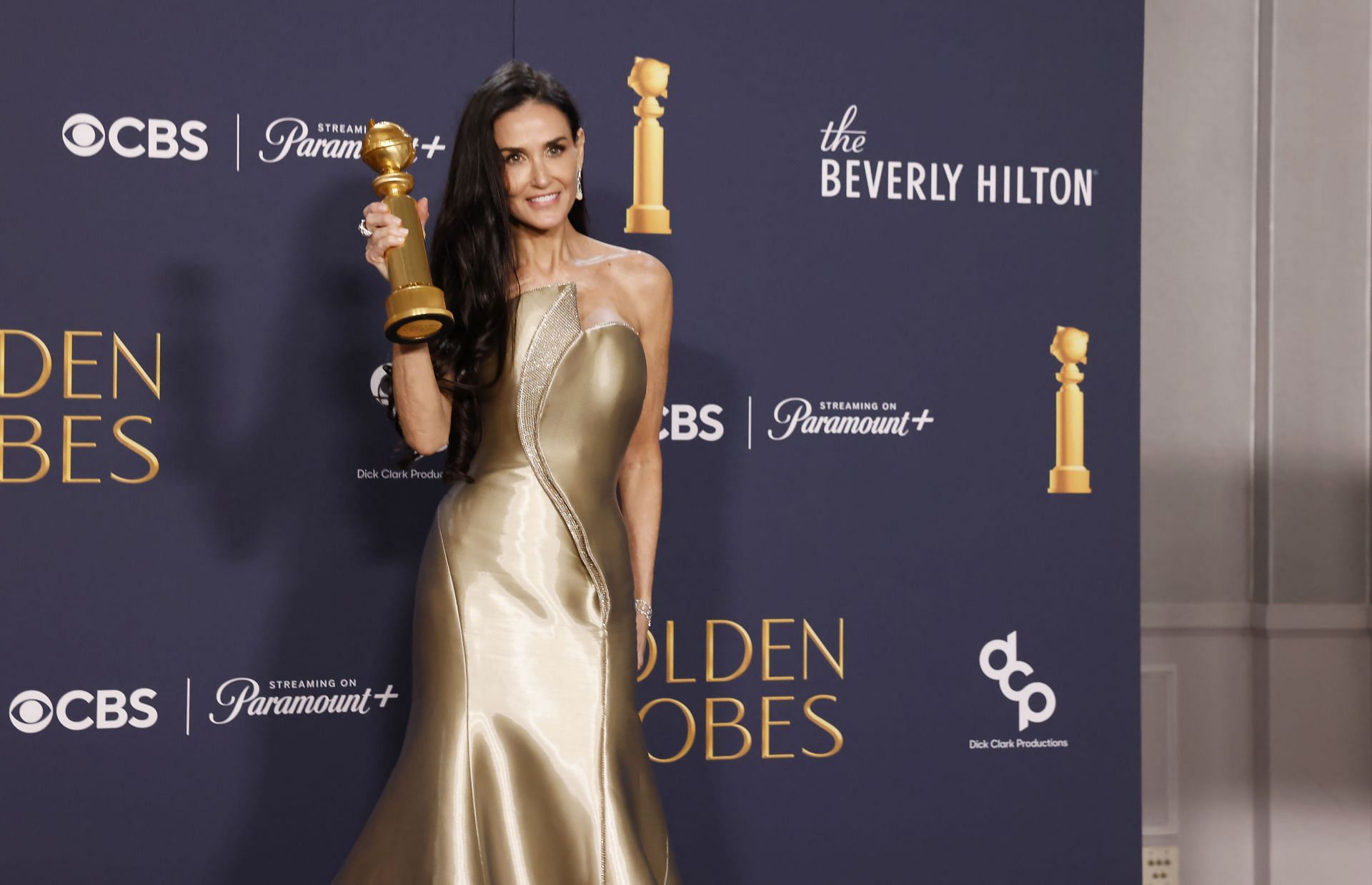 Demi Moore with her Golden Globe for Best Performance by a Female Actor in a Motion Picture Musical or Comedy for &quot;The Substance&quot; at the 82nd Golden Globe Awards (Image via Jason Armond / Los Angeles Times via Getty Images)