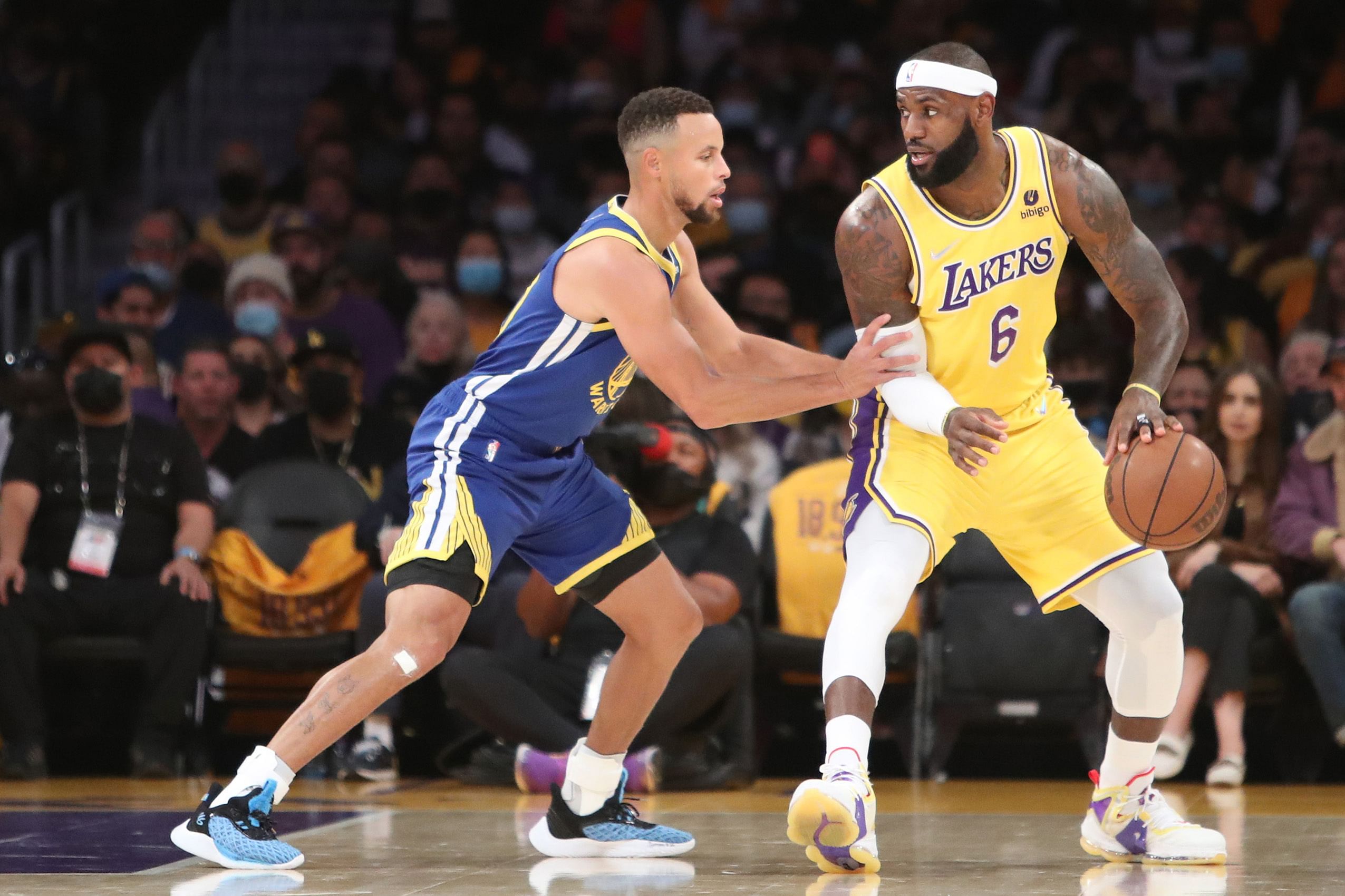 Los Angeles Lakers forward LeBron James dribbles against Golden State Warriors guard Stephen Curry (30) at Staples Center. Photo Credit: Imagn