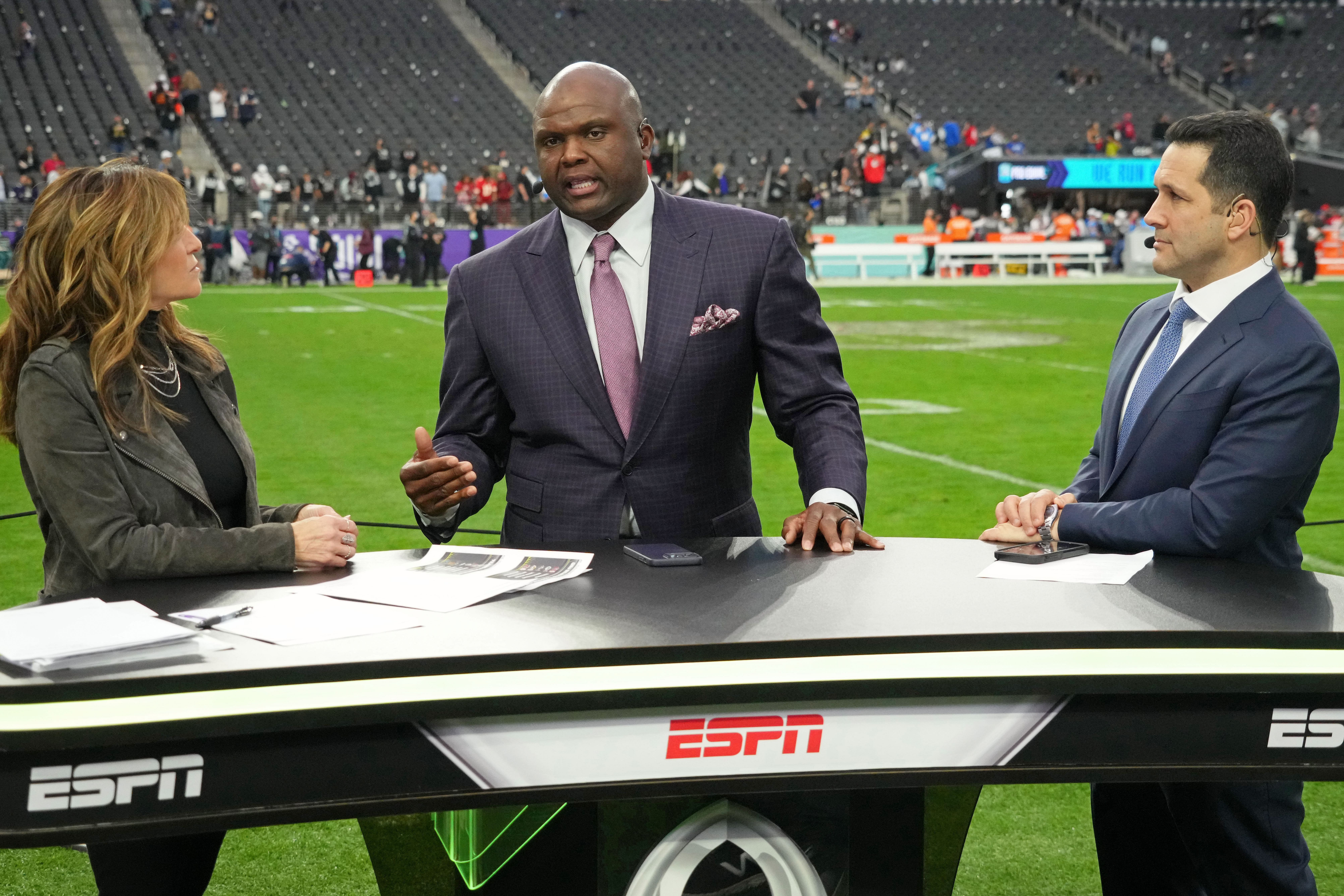 ESPN personalities Suzy Kolber (left) and Booger McFarland (center) and Adam Schefter (right) talk after the Pro Bowl football game at Allegiant Stadium - Source: Imagn