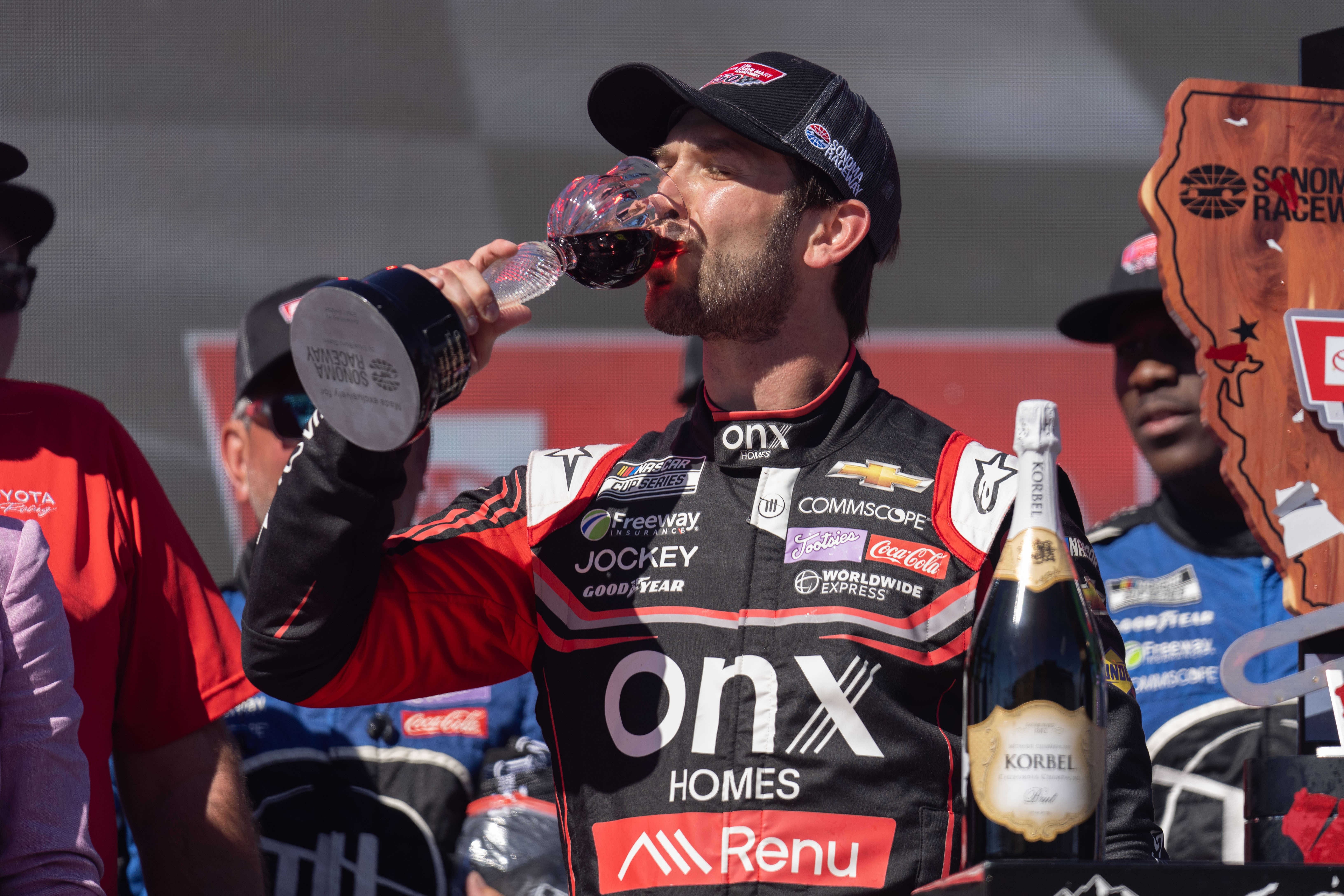 NASCAR Cup Series driver Daniel Suarez (99) of Trackhouse Racing celebrates the win with a drink of wine at the NASCAR Toyota - Save Mart 350 event at Sonoma Raceway. - Source: Imagn Images