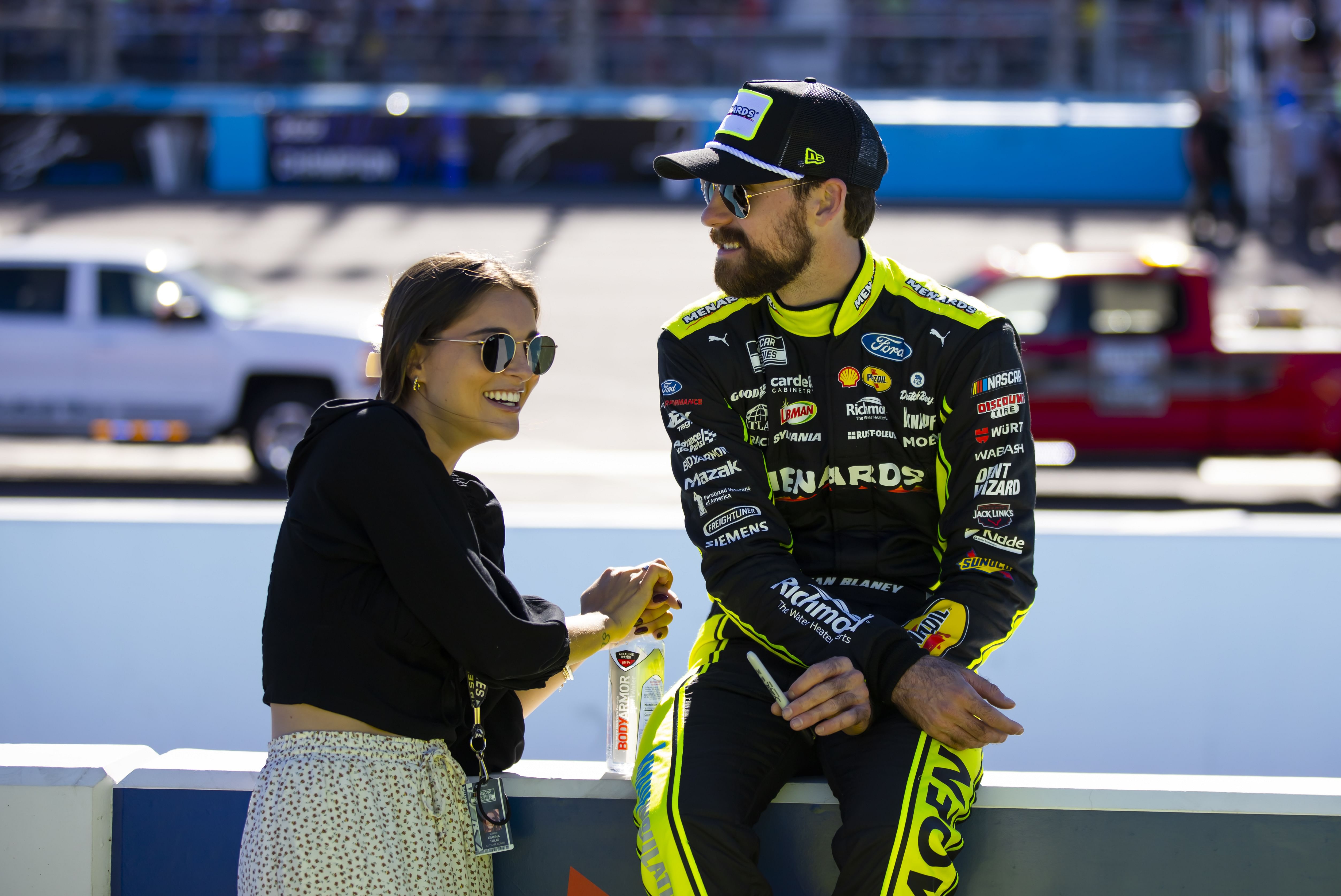 Nov 6, 2022; Avondale, Arizona, USA; NASCAR Cup Series driver Ryan Blaney (right) with girlfriend Gianna Tulio during the Cup Championship race at Phoenix Raceway. Mandatory Credit: Mark J. Rebilas-Imagn Images - Source: Imagn