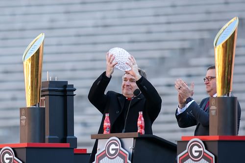 Jan 14, 2023; Athens, GA, USA; Georgia Bulldogs head coach Kirby Smart holds up the coaches trophy at the national championship celebration at Sanford Stadium.  - Source: Imagn