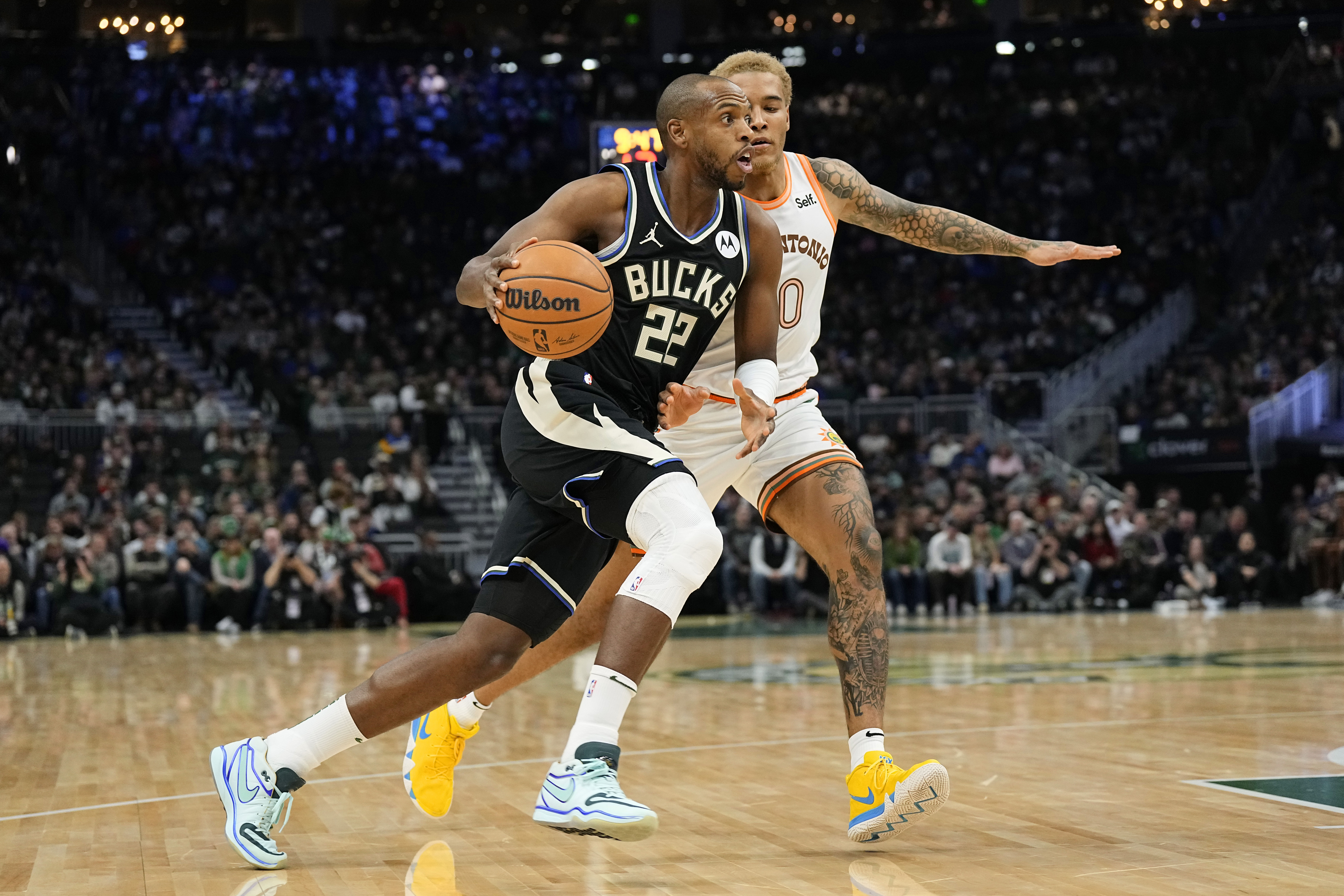 Milwaukee Bucks forward Khris Middleton drives for the basket against San Antonio Spurs forward Jeremy Sochan at Fiserv Forum. Photo Credit: Imagn