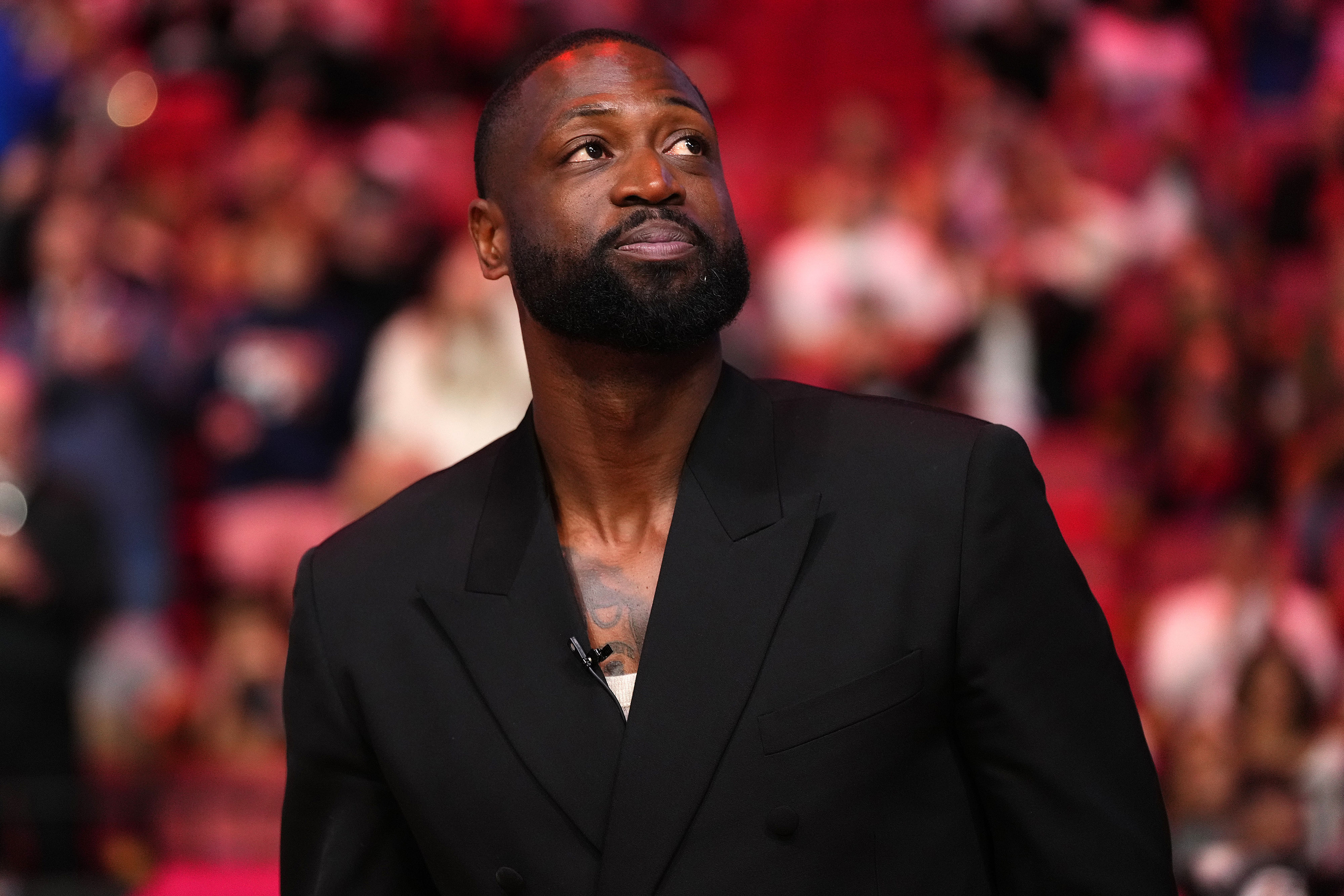 Former Miami Heat player Dwayne Wade reacts after learning a statue will be erected outside of Kaseya Center in 2025, during a game between the Miami Heat and the Charlotte Hornets. Photo Credit: Imagn