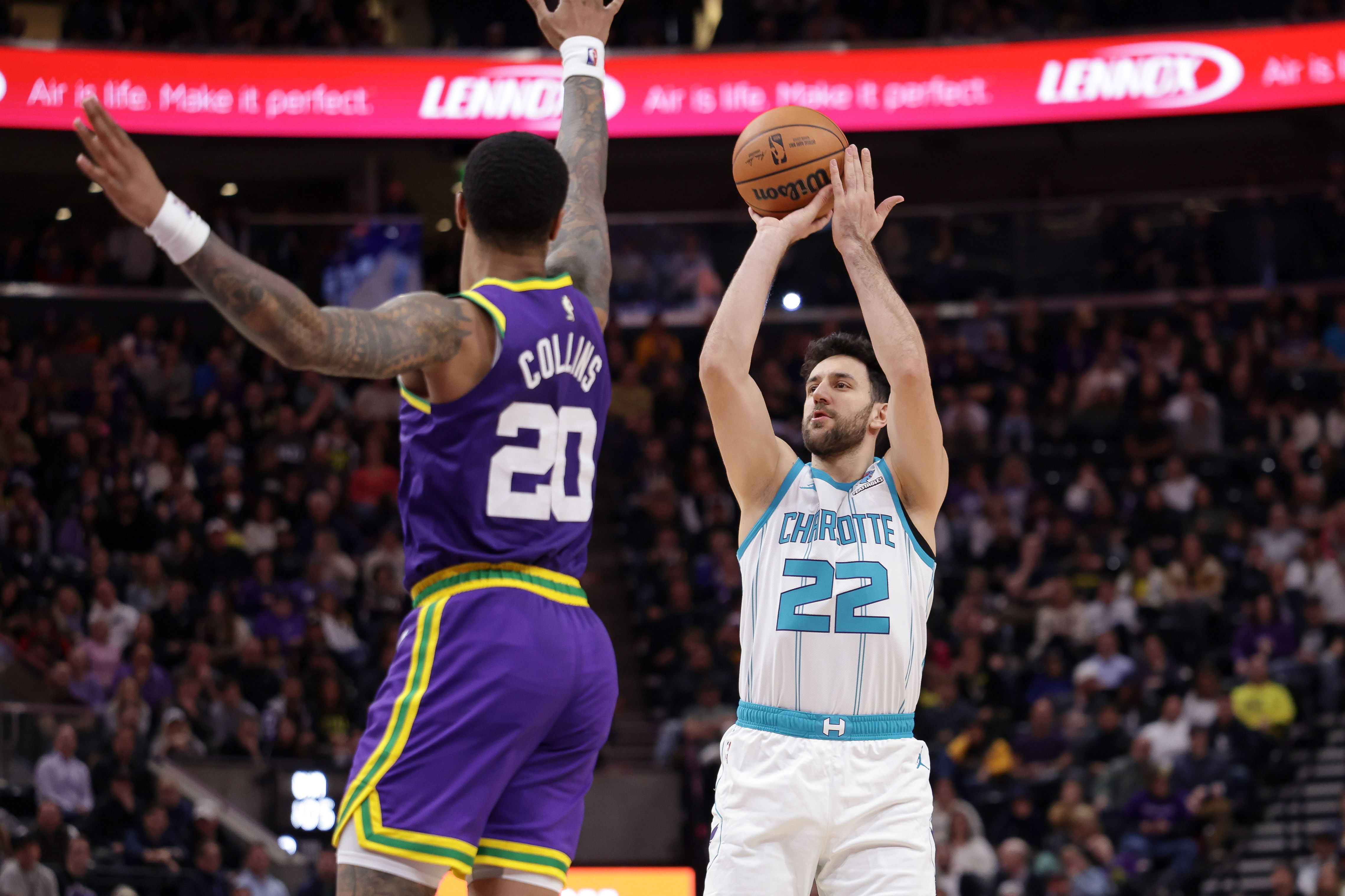 Feb 22, 2024; Salt Lake City, Utah, USA; Charlotte Hornets guard Vasilije Micic (22) shoots the ball over Utah Jazz forward John Collins (20) during the second half at Delta Center. Mandatory Credit: Chris Nicoll-Imagn Images - Source: Imagn