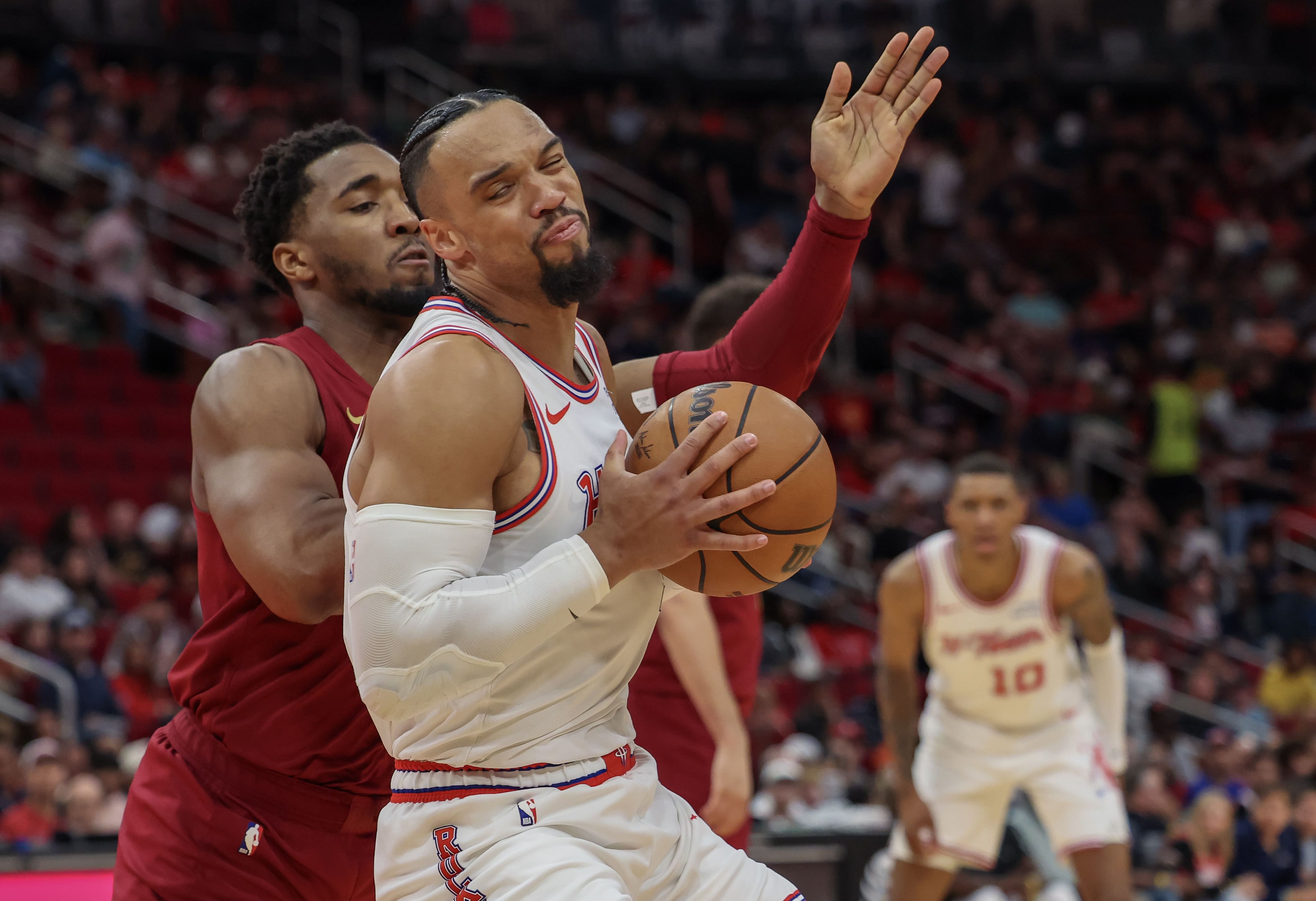 Houston Rockets forward Dillon Brooks makes a spin move against Cleveland Cavaliers guard Donovan Mitchell at Toyota Center. Photo Credit: Imagn