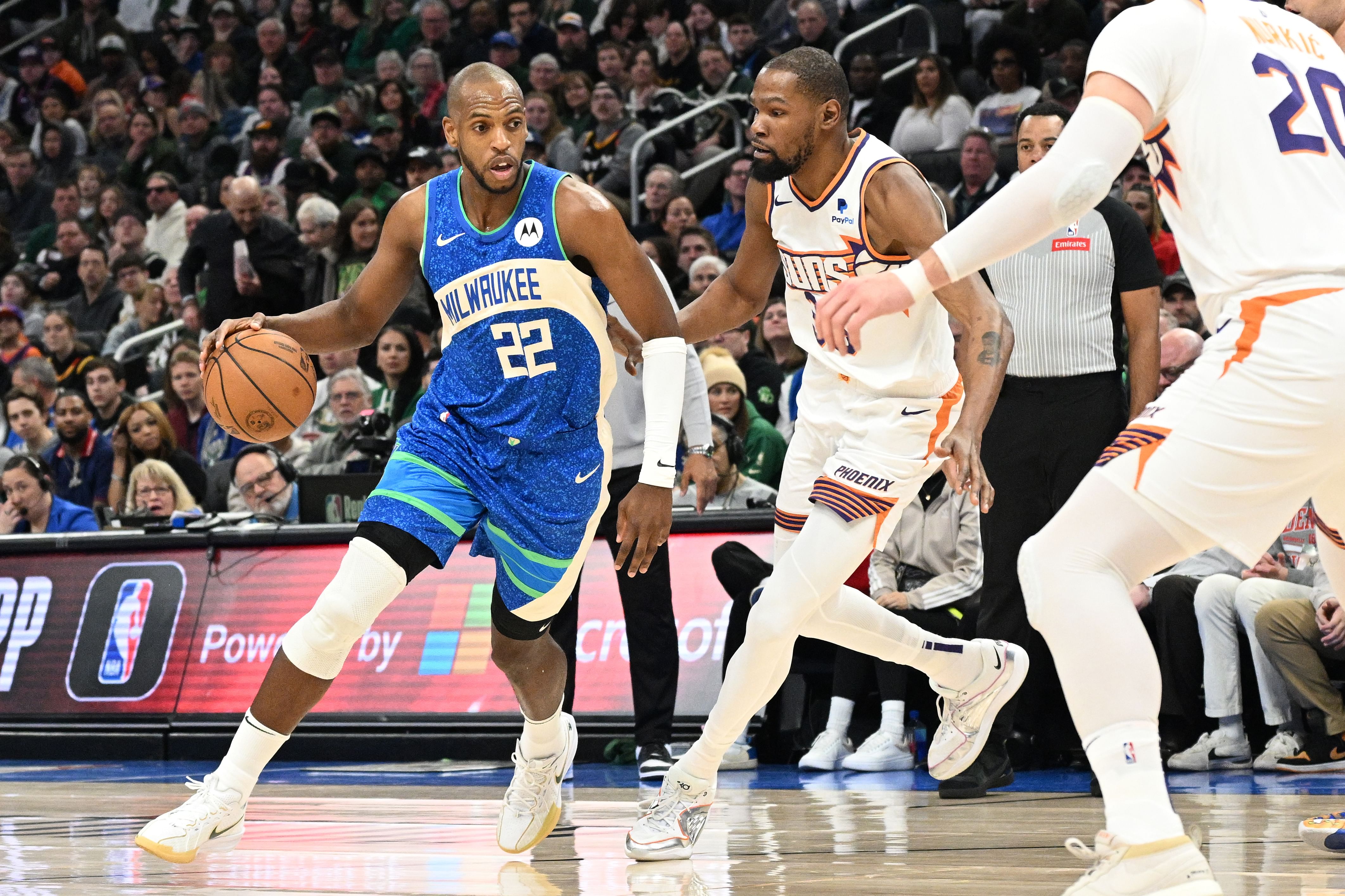 Milwaukee Bucks forward Khris Middleton (22) drives against the Phoenix Suns during an NBA game. (Credits: IMAGN)