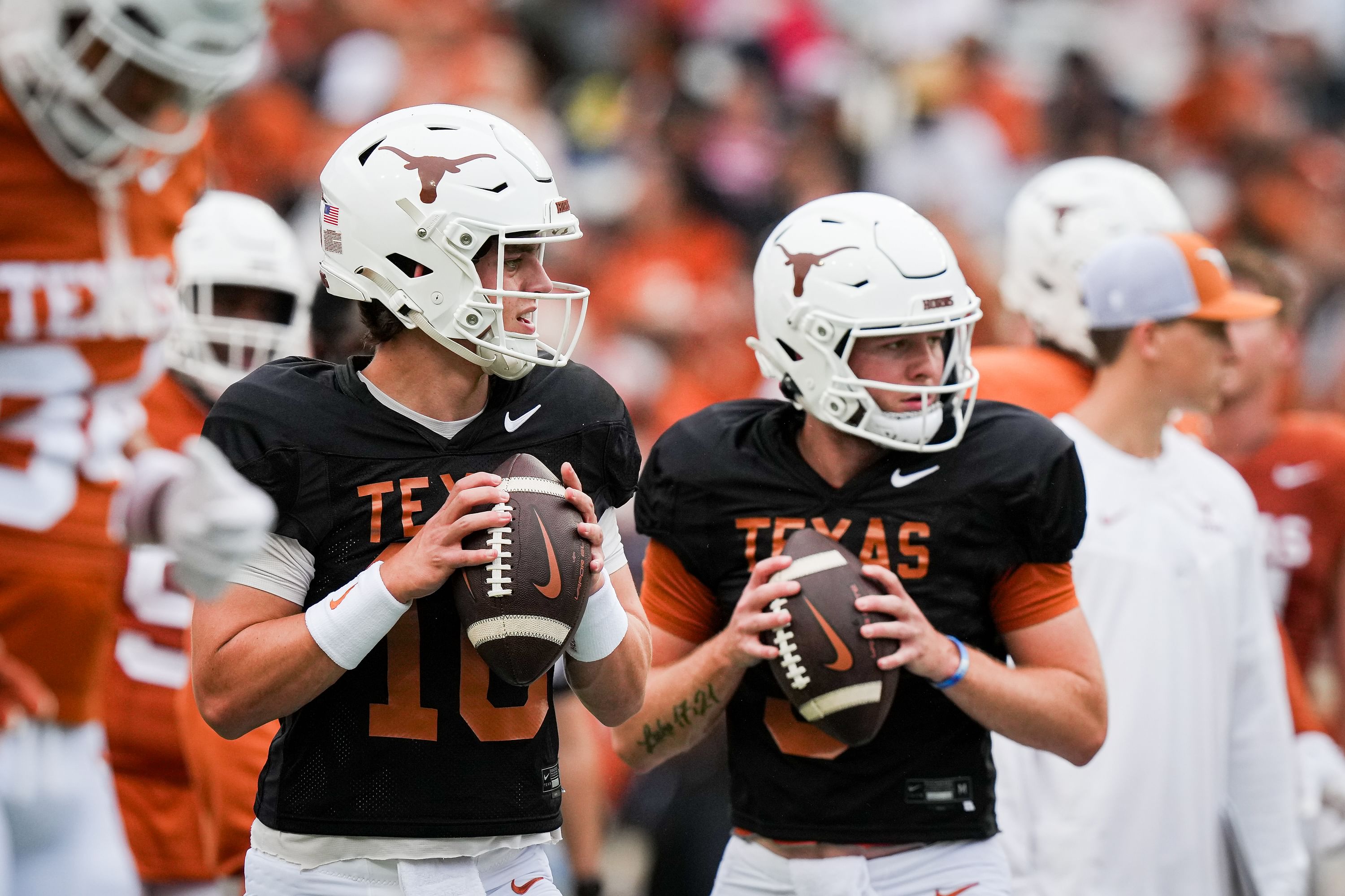 Texas Longhorns quarterbacks Arch Manning (16), left, and Quinn Ewers (3) throw passes while warming up - Source: Imagn