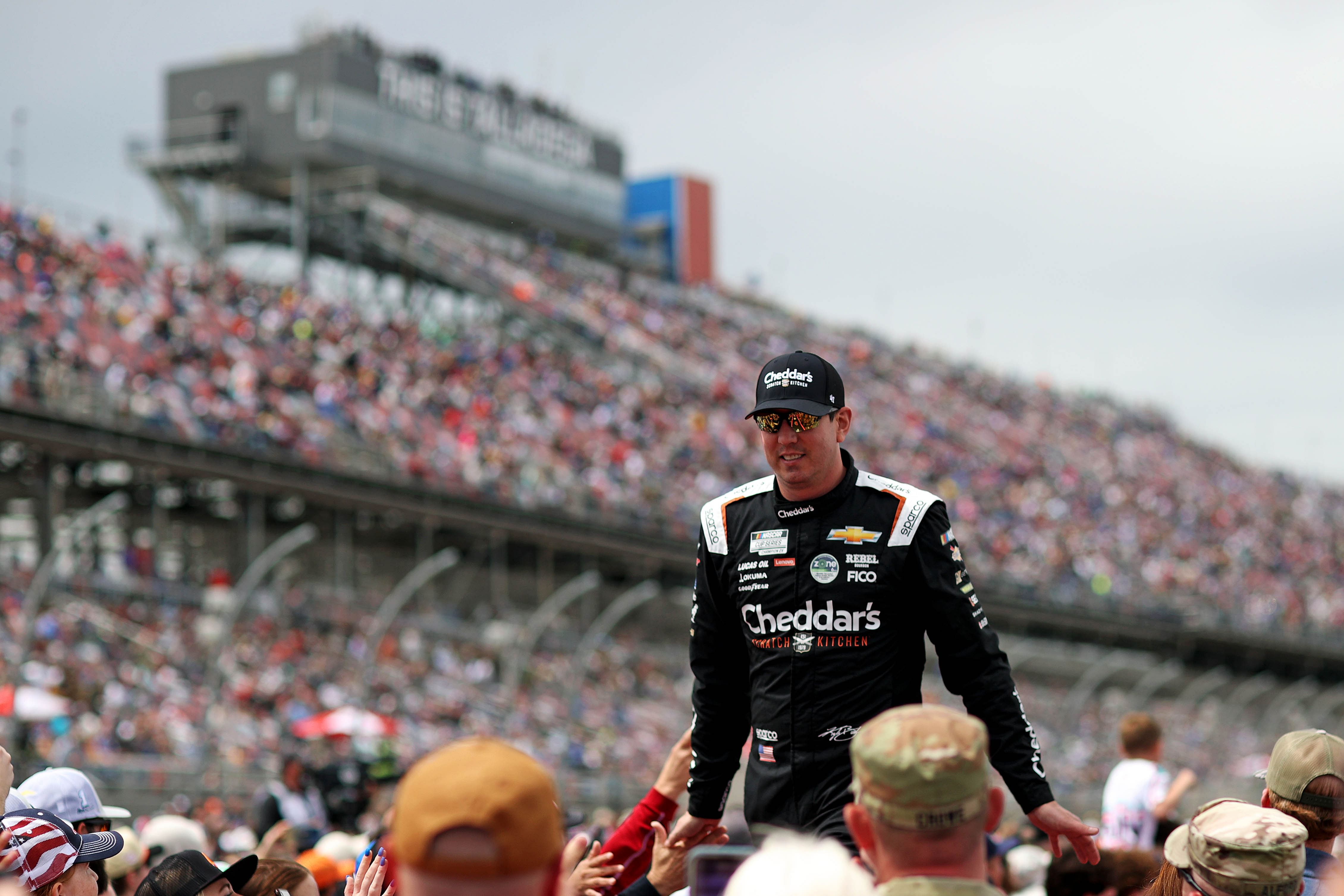 Apr 21, 2024; Talladega, Alabama, USA; NASCAR Cup Series driver Kyle Busch (8) high fives fan before the GEICO 500 at Talladega Superspeedway. Mandatory Credit: Peter Casey-Imagn Images - Source: Imagn