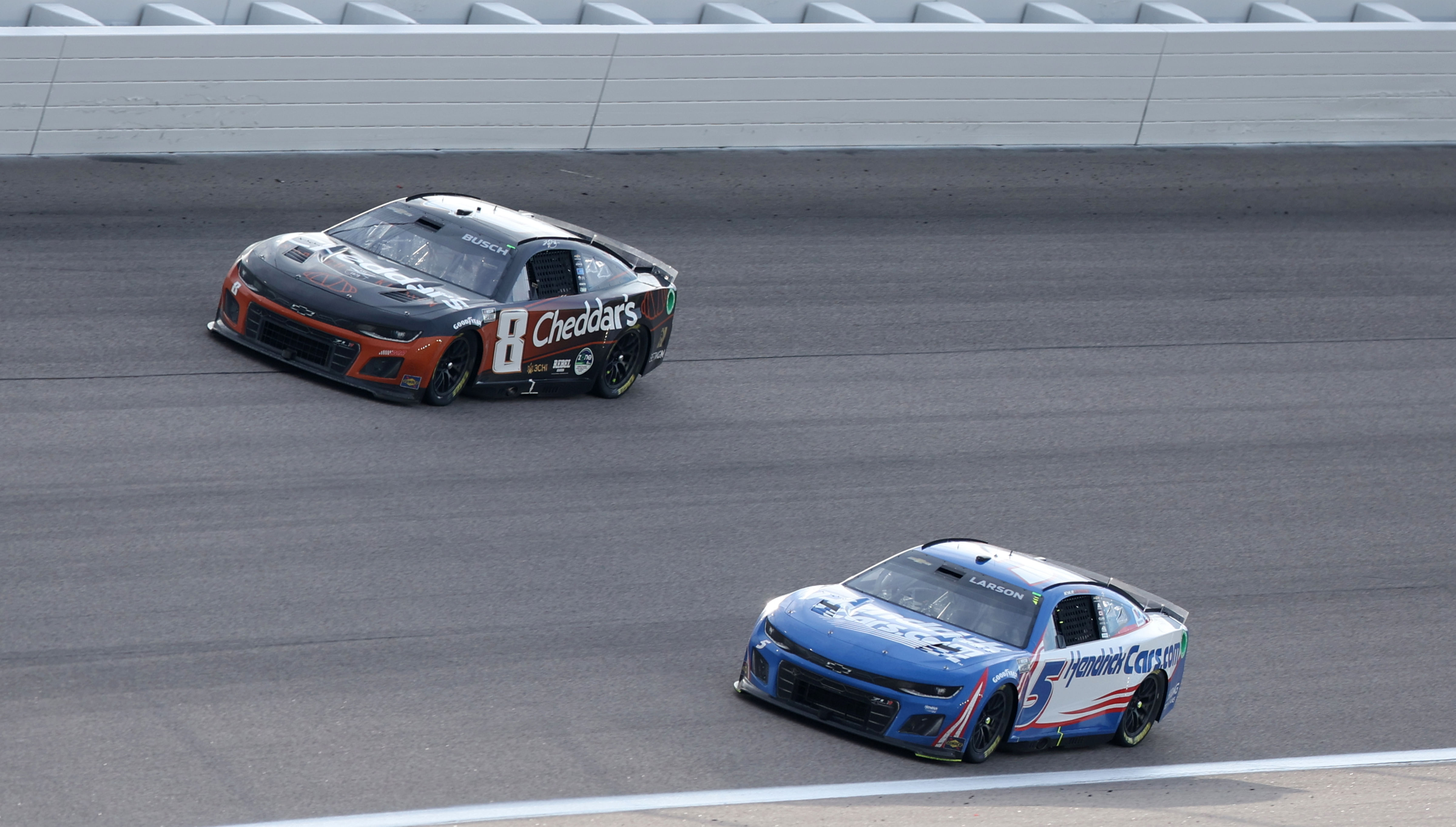 NASCAR Cup Series driver Kyle Larson (5) drives underneath NASCAR Cup Series driver Kyle Busch (8) during the Advent Health 400 at the Kansas Speedway. - Source: Imagn