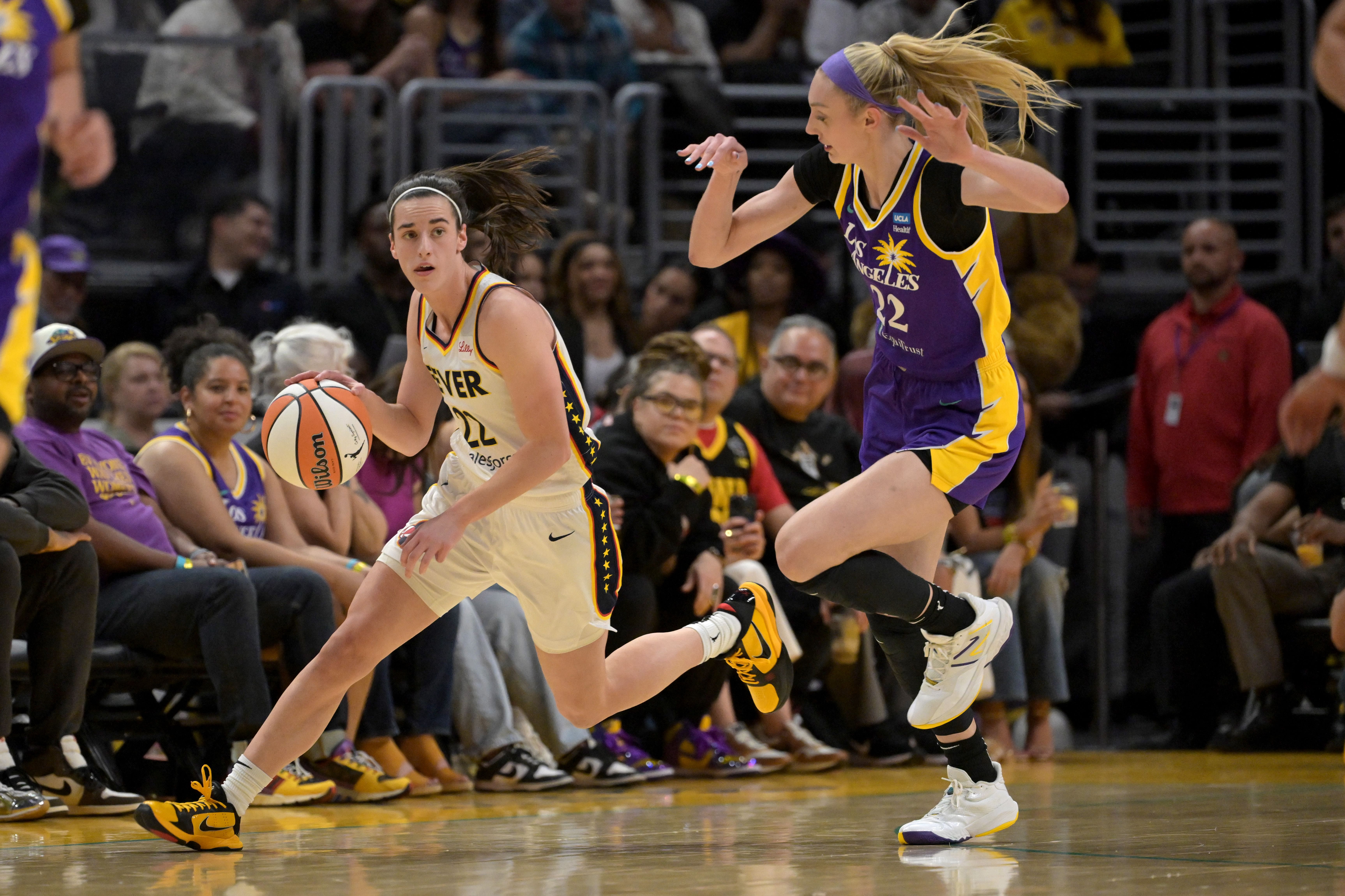 Indiana Fever guard Caitlin Clark and Los Angeles Sparks forward Cameron Brink at Crypto.com Arena. Photo Credit: Imagn