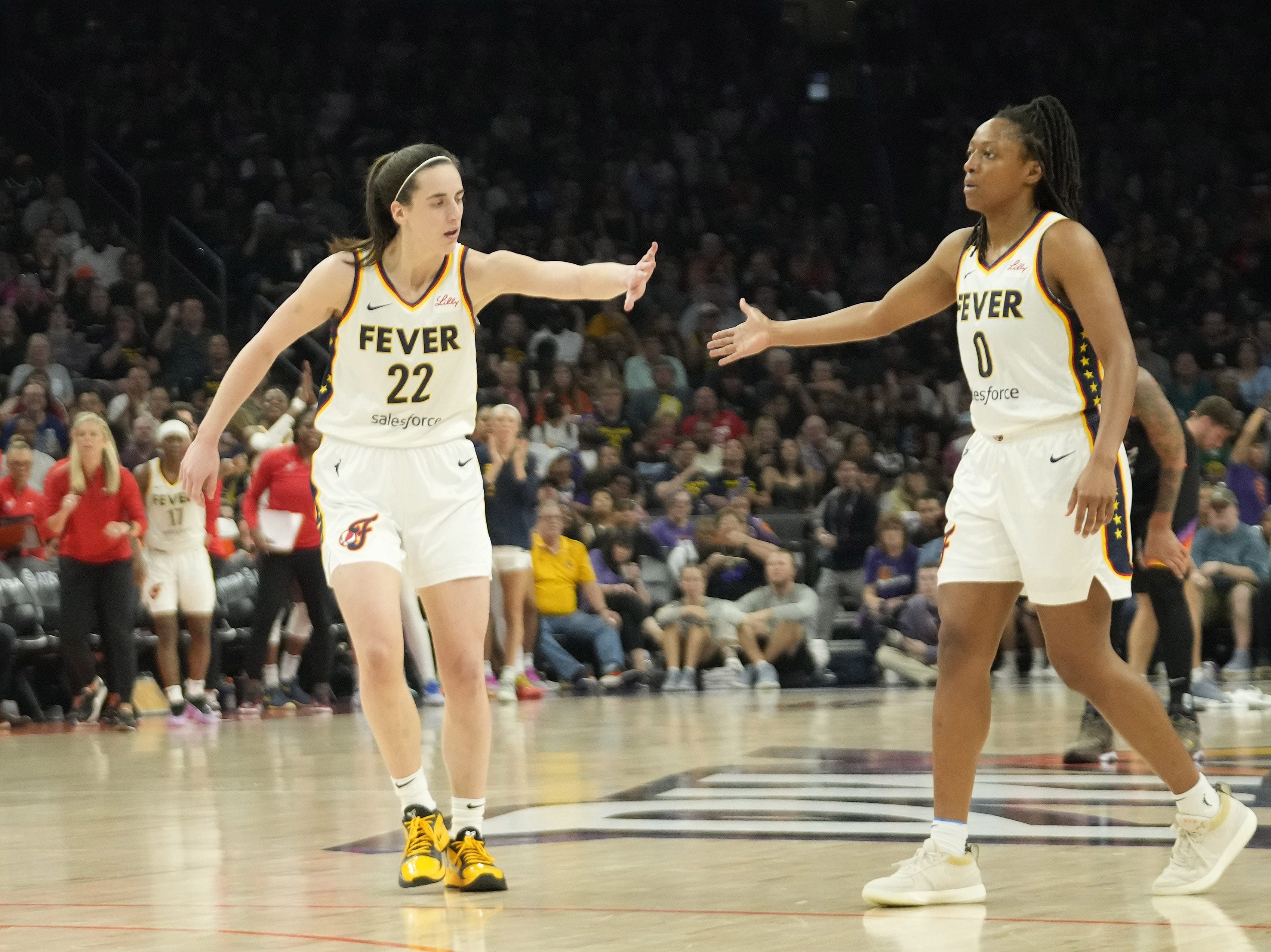 Indiana Fever guard Caitlin Clark with guard Kelsey Mitchell against the Phoenix Mercury at Footprint Center. Photo Credit: Imagn