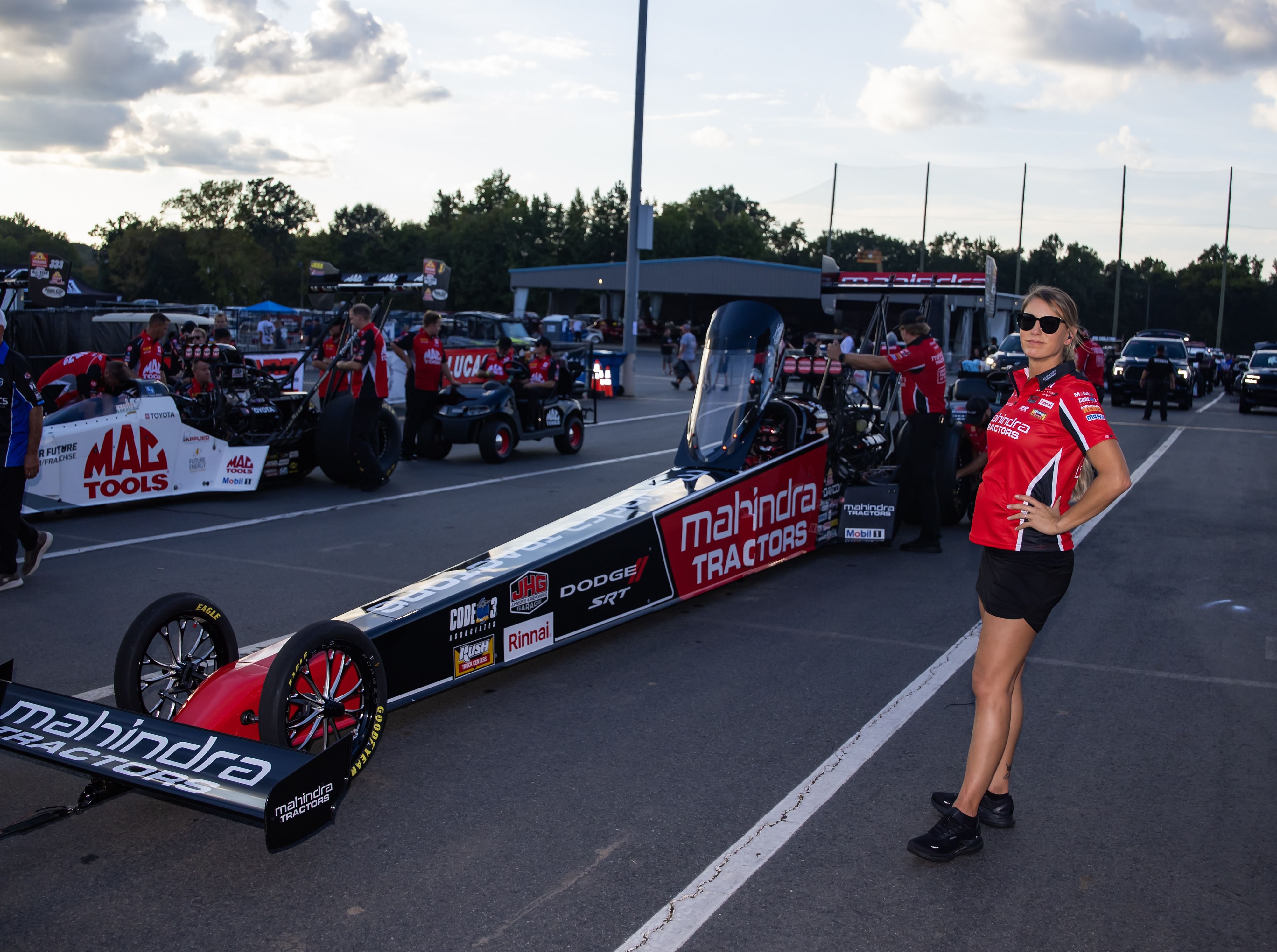 Pregnant NHRA driver Leah Pruett stands alongside the dragster of husband, top fuel driver Tony Stewart during qualifying for the Carolina Nationals - Source: Imagn