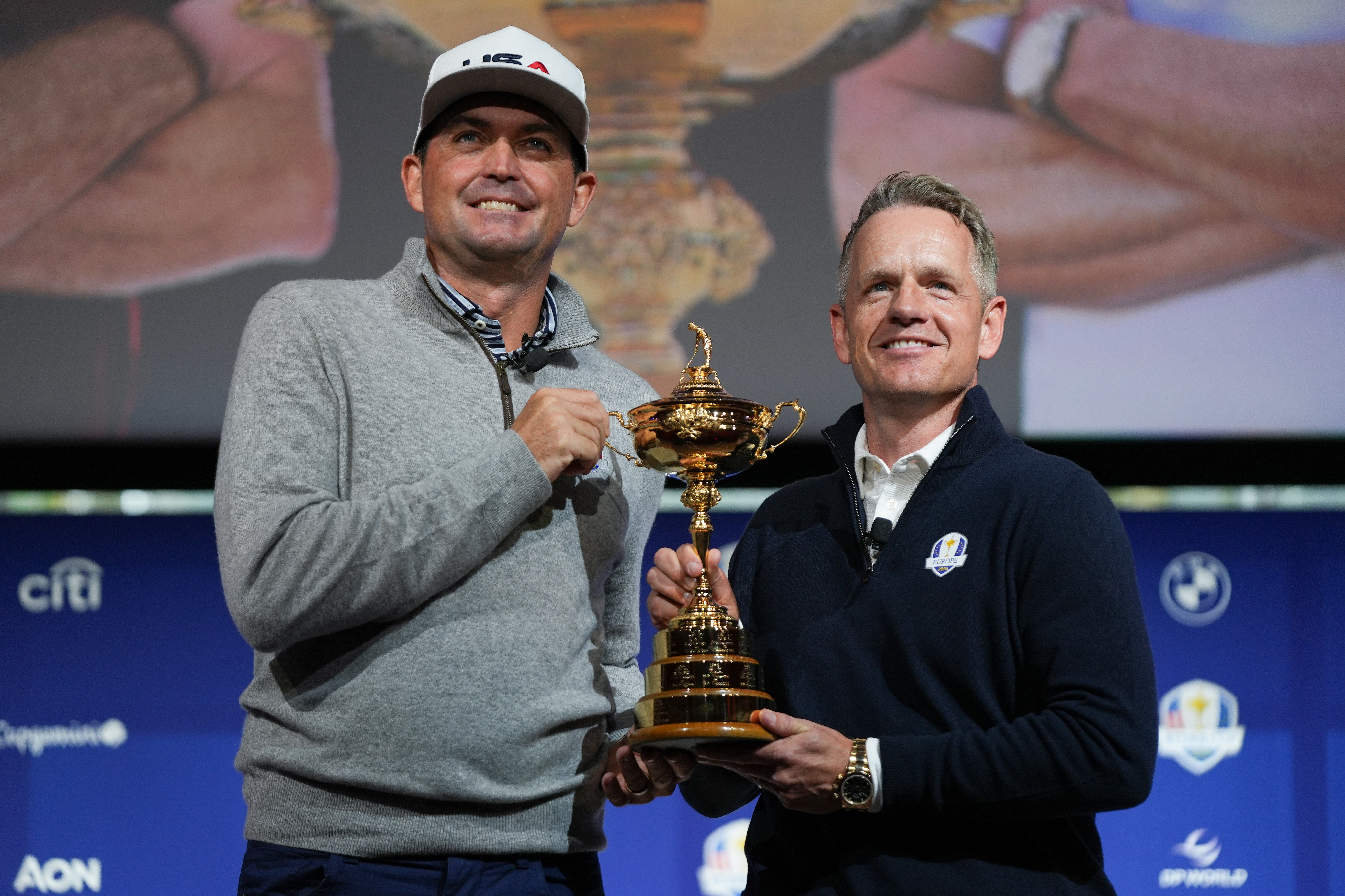  Keegan Bradley and Luke Donald take a photo with the Ryder Cup after a press conference at Times Center. - Source: Imagn