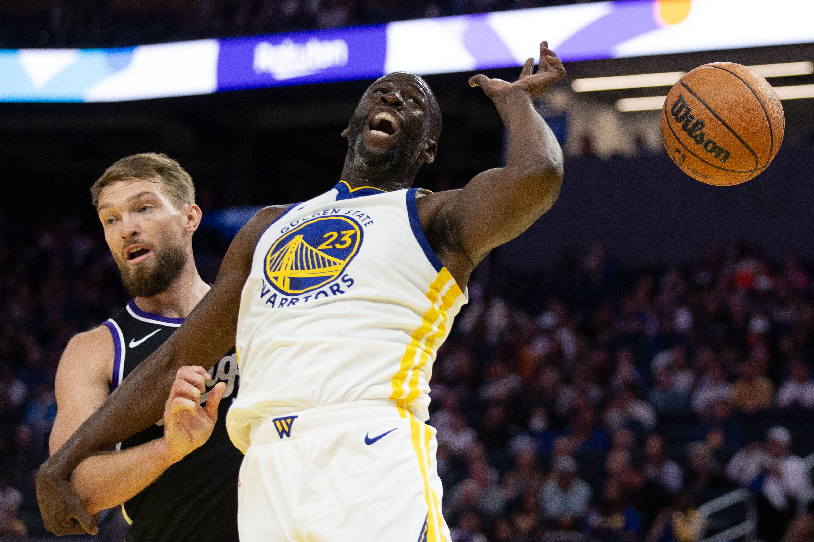 Oct 11, 2024; San Francisco, California, USA; Sacramento Kings forward Domantas Sabonis (11) and Golden State Warriors forward Draymond Green (23) vie for a rebound during the first quarter at Chase Center. Mandatory Credit: D. Ross Cameron-Imagn Images - Source: Imagn