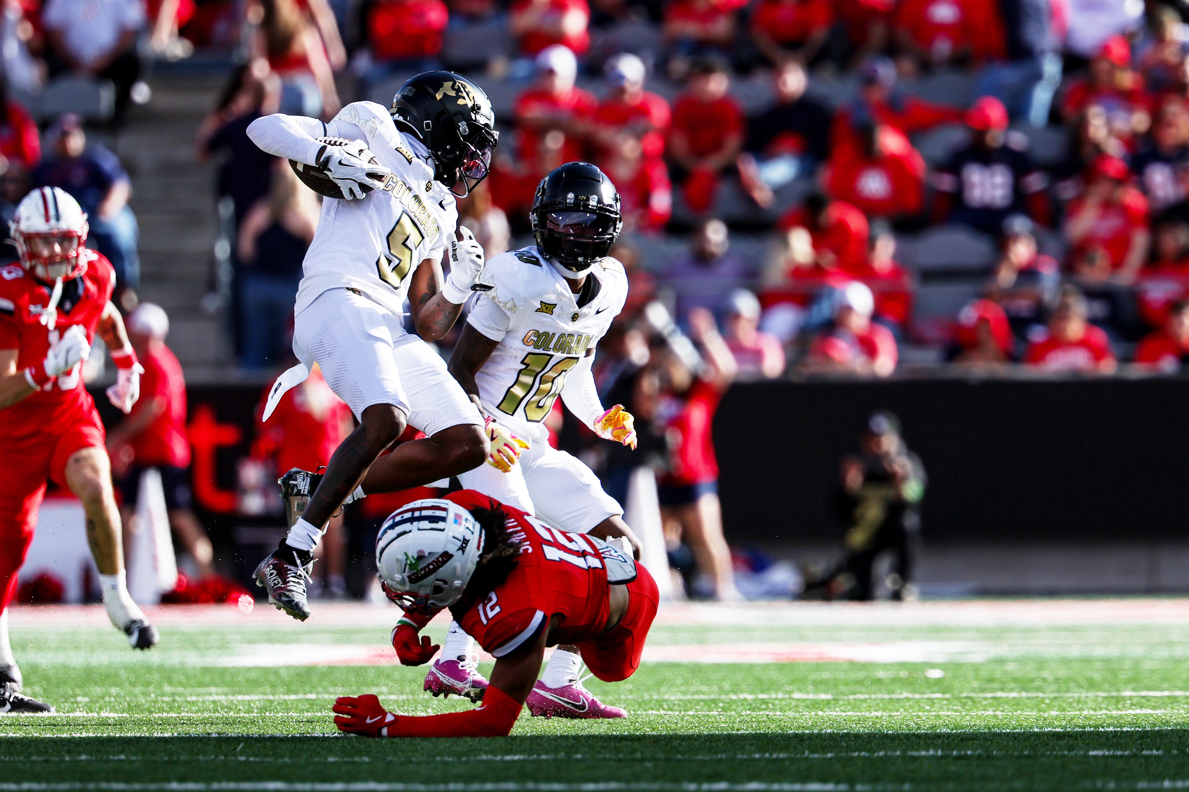 Colorado Buffaloes wide receiver Jimmy Horn Jr. (5) jumps over Arizona Wildcats defensive back Genesis Smith (12) - Source: Imagn