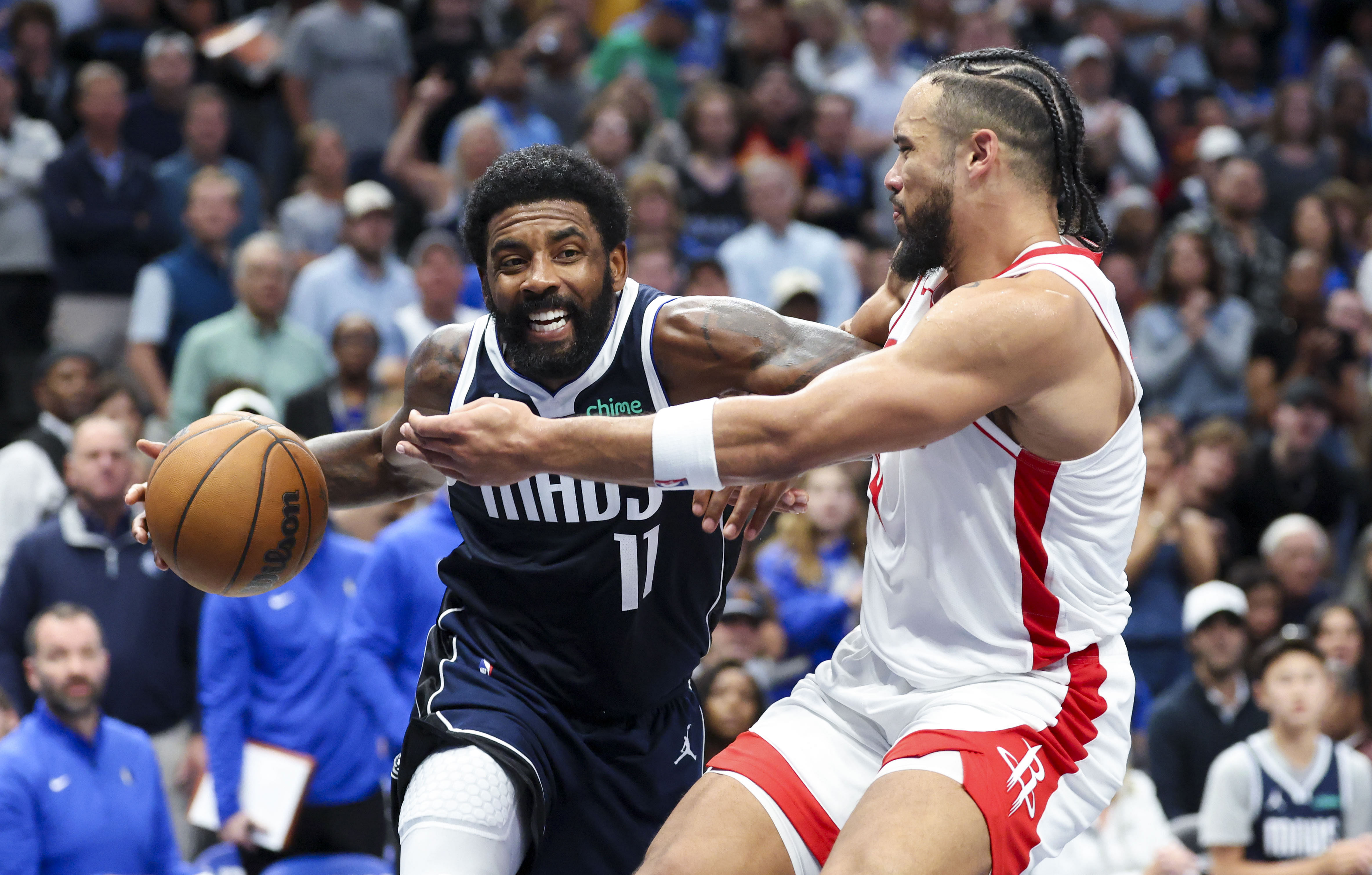 Dallas Mavericks guard Kyrie Irving drives to the basket as Houston Rockets forward Dillon Brooks defends at American Airlines Center. Photo Credit: Images