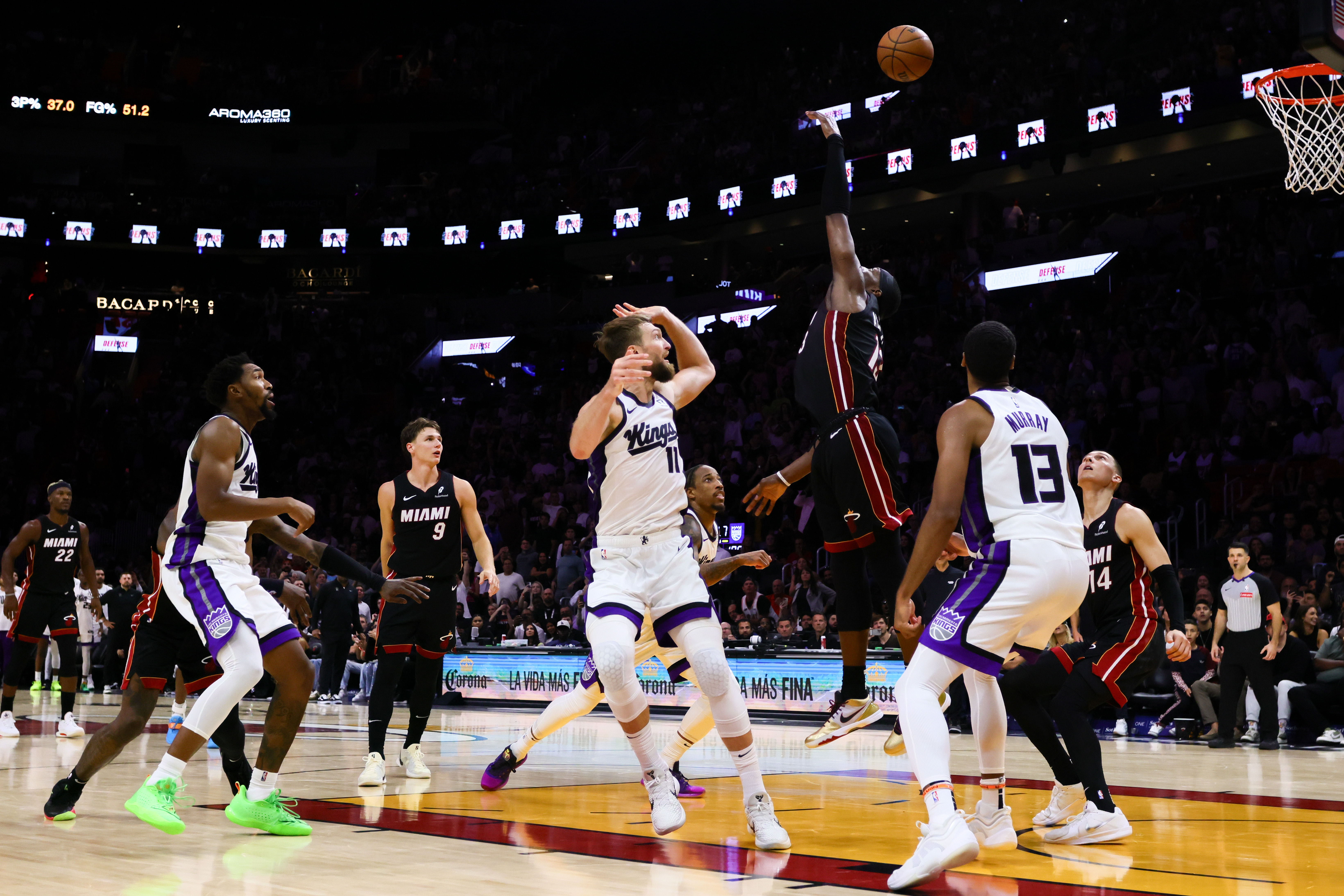 Nov 4, 2024; Miami, Florida, USA; Sacramento Kings forward Domantas Sabonis (11) shoots the game-winning basket over Miami Heat center Bam Adebayo (13) during the fourth quarter at Kaseya Center. Mandatory Credit: Sam Navarro-Imagn Images - Source: Imagn