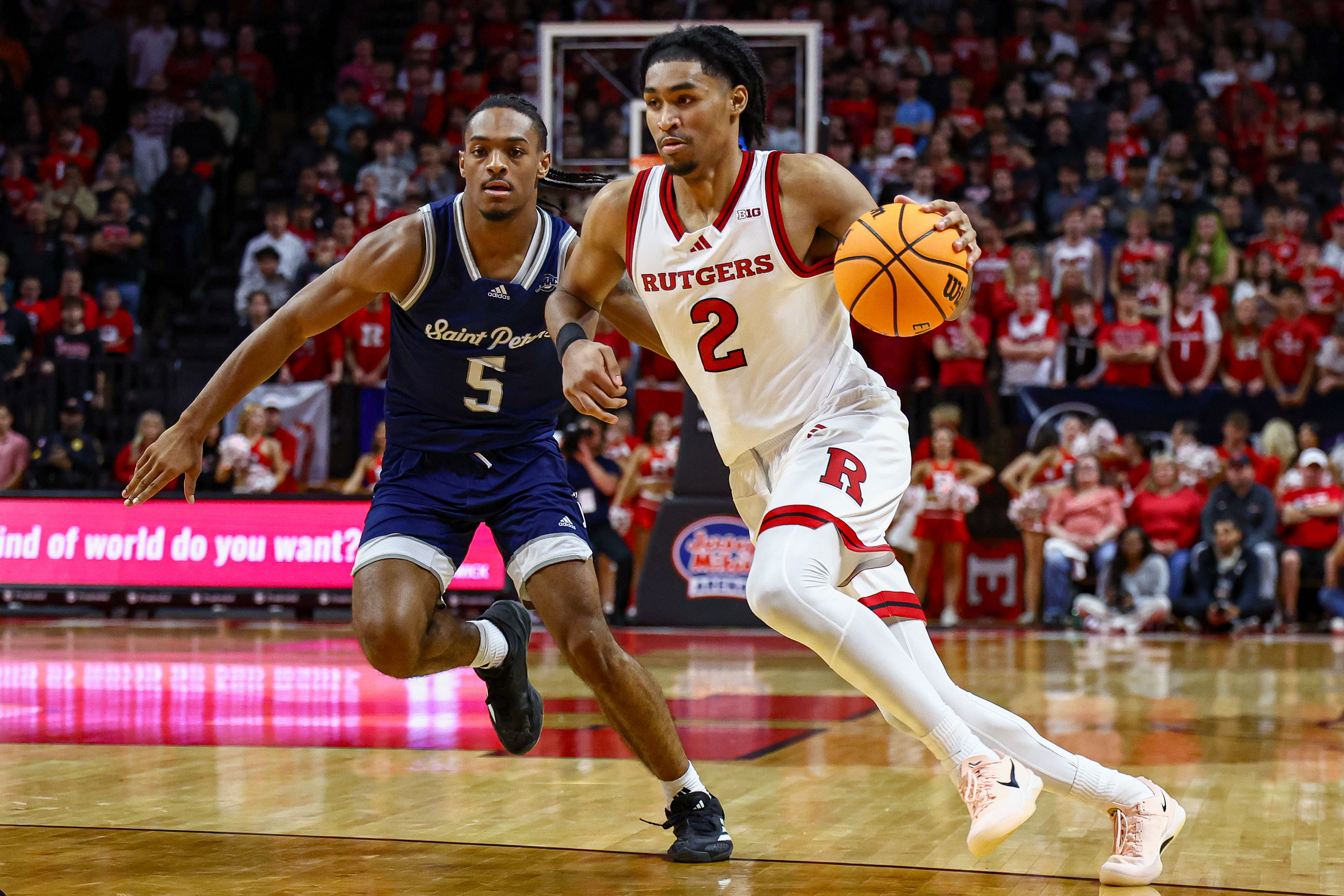 Rutgers Scarlet Knights guard Dylan Harper drives to the basket as St. Peter&#039;s Peacocks guard Armoni Zeigler defends at Jersey Mike&#039;s Arena. Photo Credit: Imagn