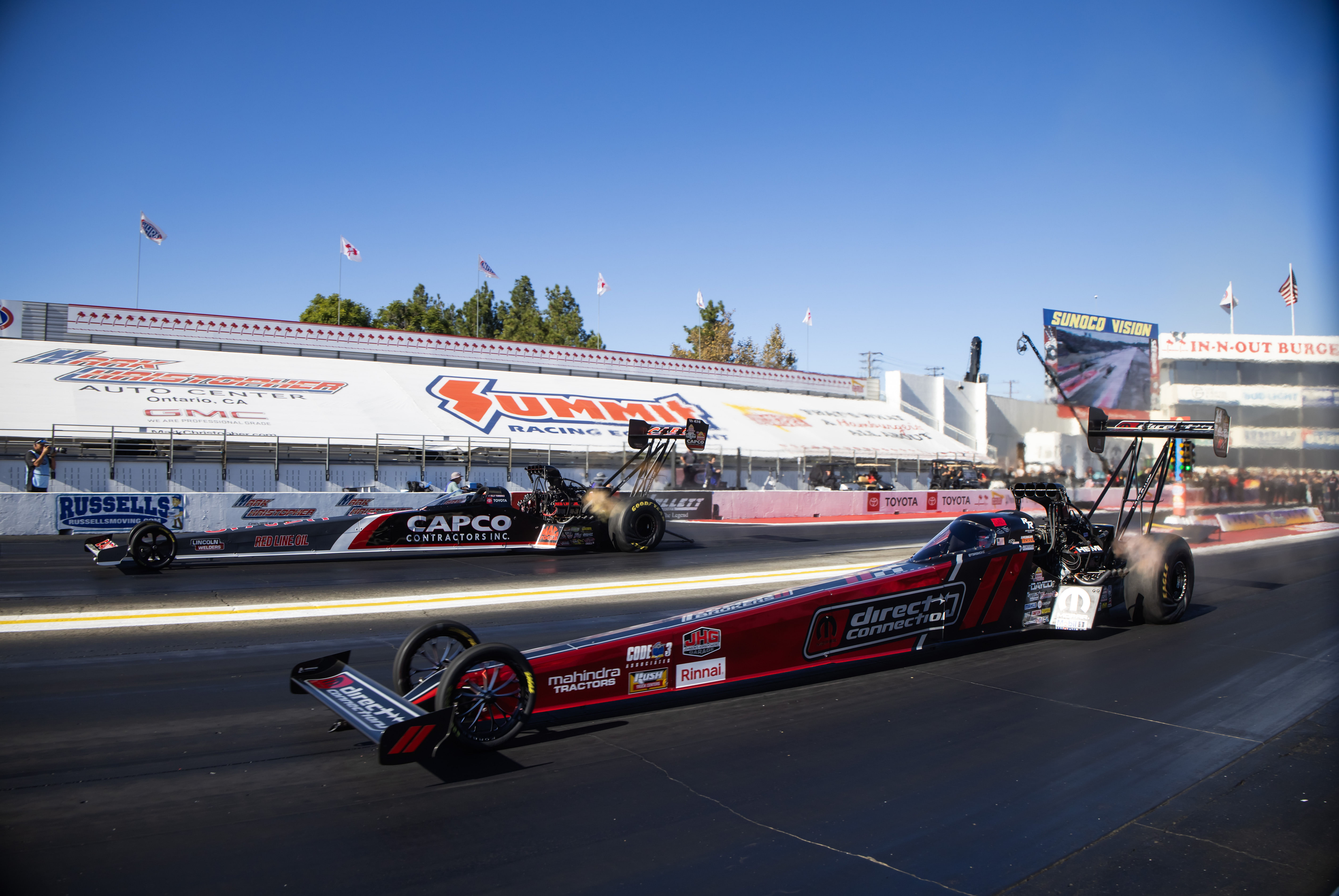 Tony Stewart (near) races alongside Billy Torrence during the NHRA Finals at In-N-Out Burger Pomona Dragstrip - Source: Imagn