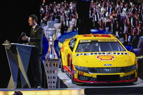 NASCAR Cup Series driver Joey Logano (22) talks to the audience after being announced as the three-time Cup champion during the NASCAR Awards Banquet - Source: Imagn