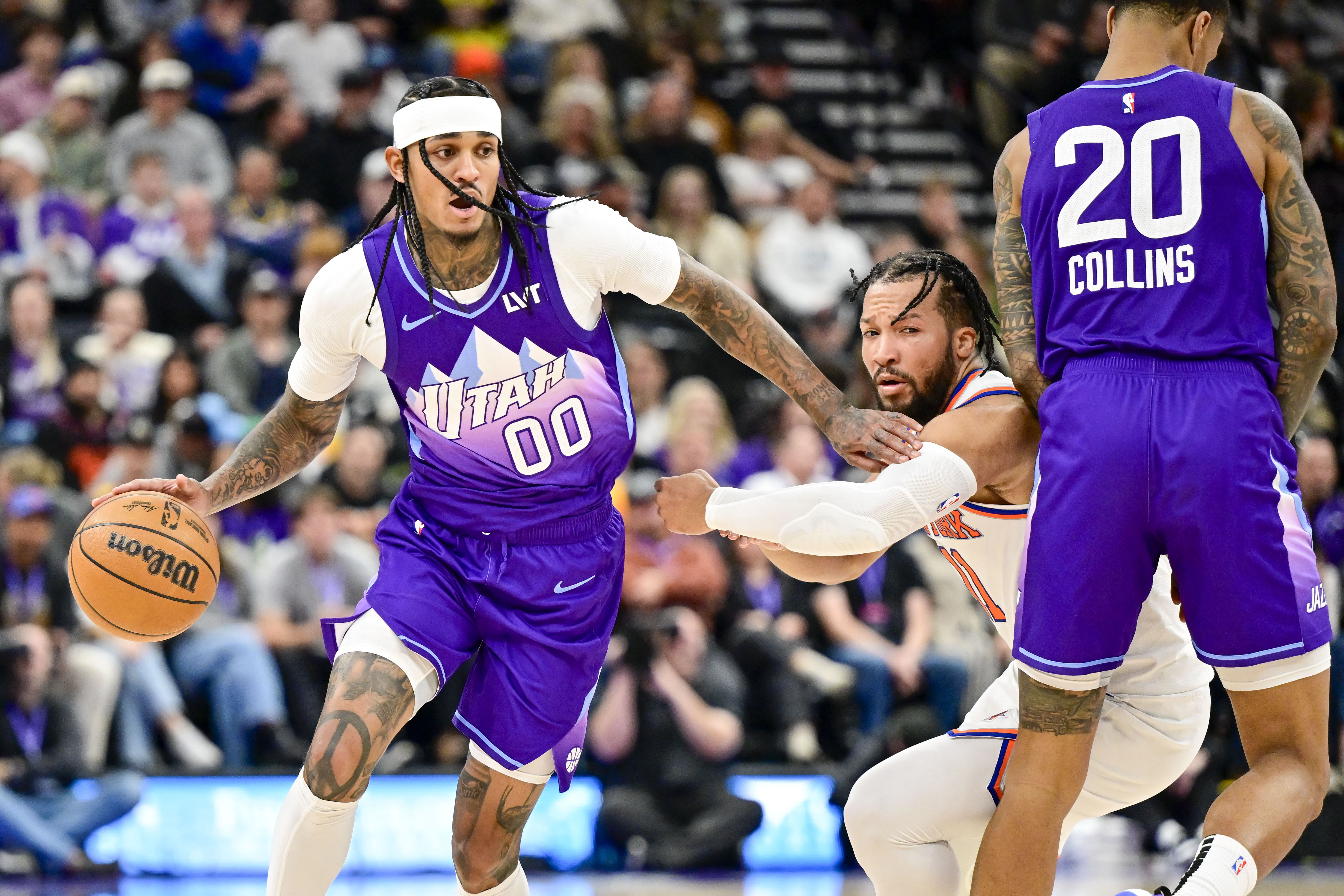 Utah Jazz guard Jordan Clarkson dribbles the ball against New York Knicks guard Jalen Brunson at the Delta Center. Photo Credit: Imagn