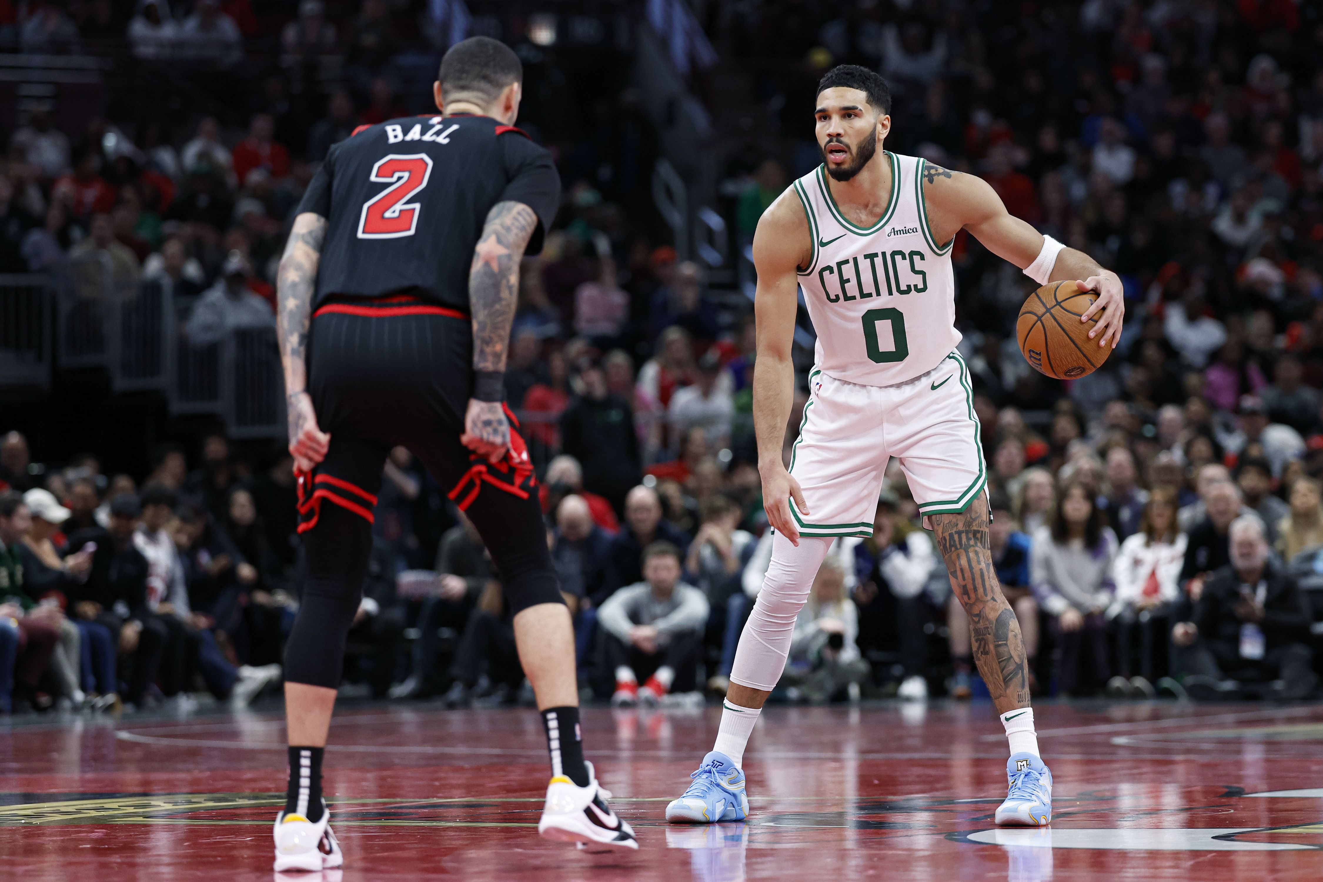 Boston Celtics forward Jayson Tatum brings the ball up court against Chicago Bulls guard Lonzo Ball at United Center. Photo Credit: Imagn