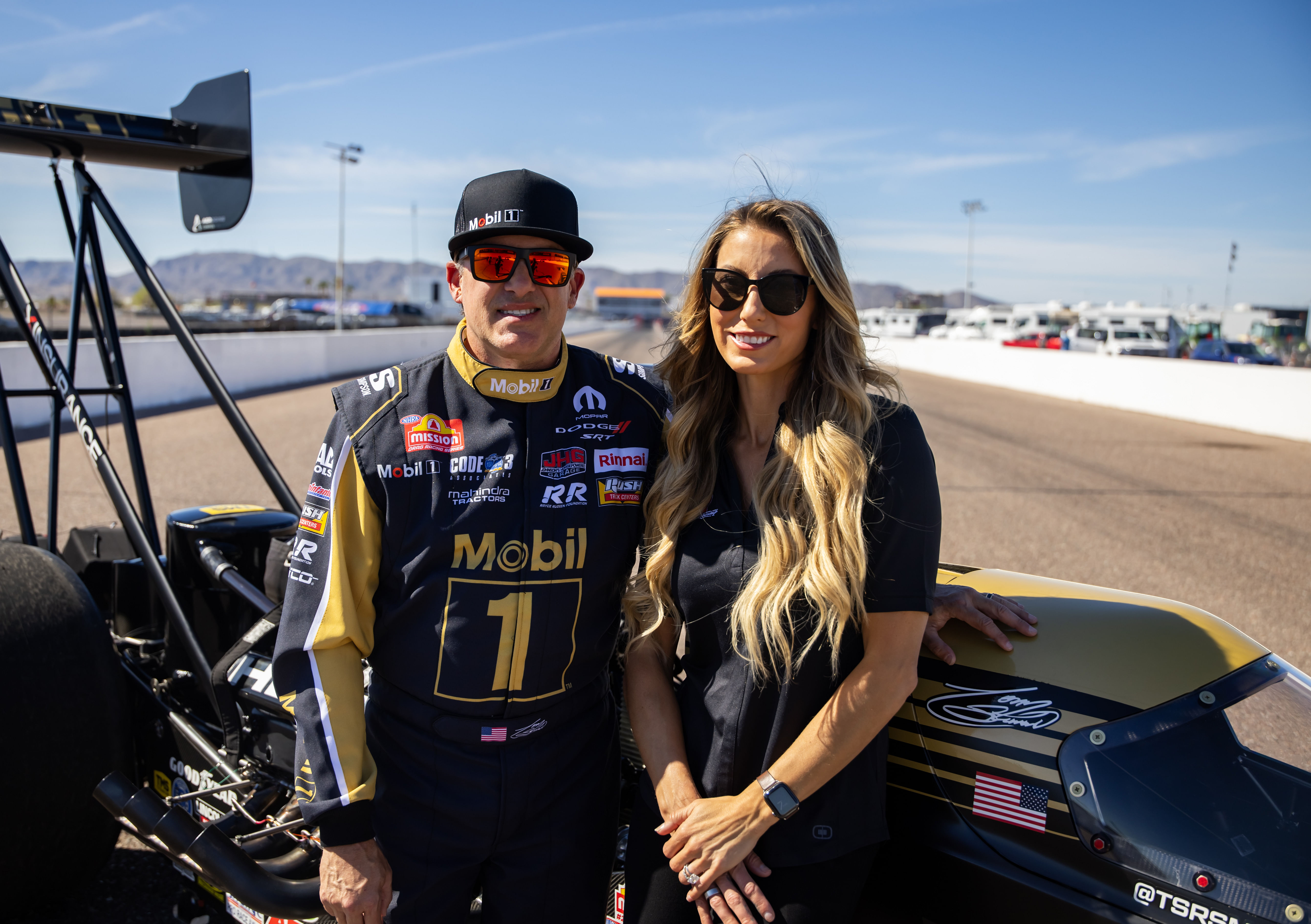 NHRA top fuel driver Tony Stewart (left) and wife Leah Pruett pose for a portrait prior to the Arizona Nationals at Firebird Motorsports Park. Mandatory Credit: Mark J. Rebilas-Imagn Images