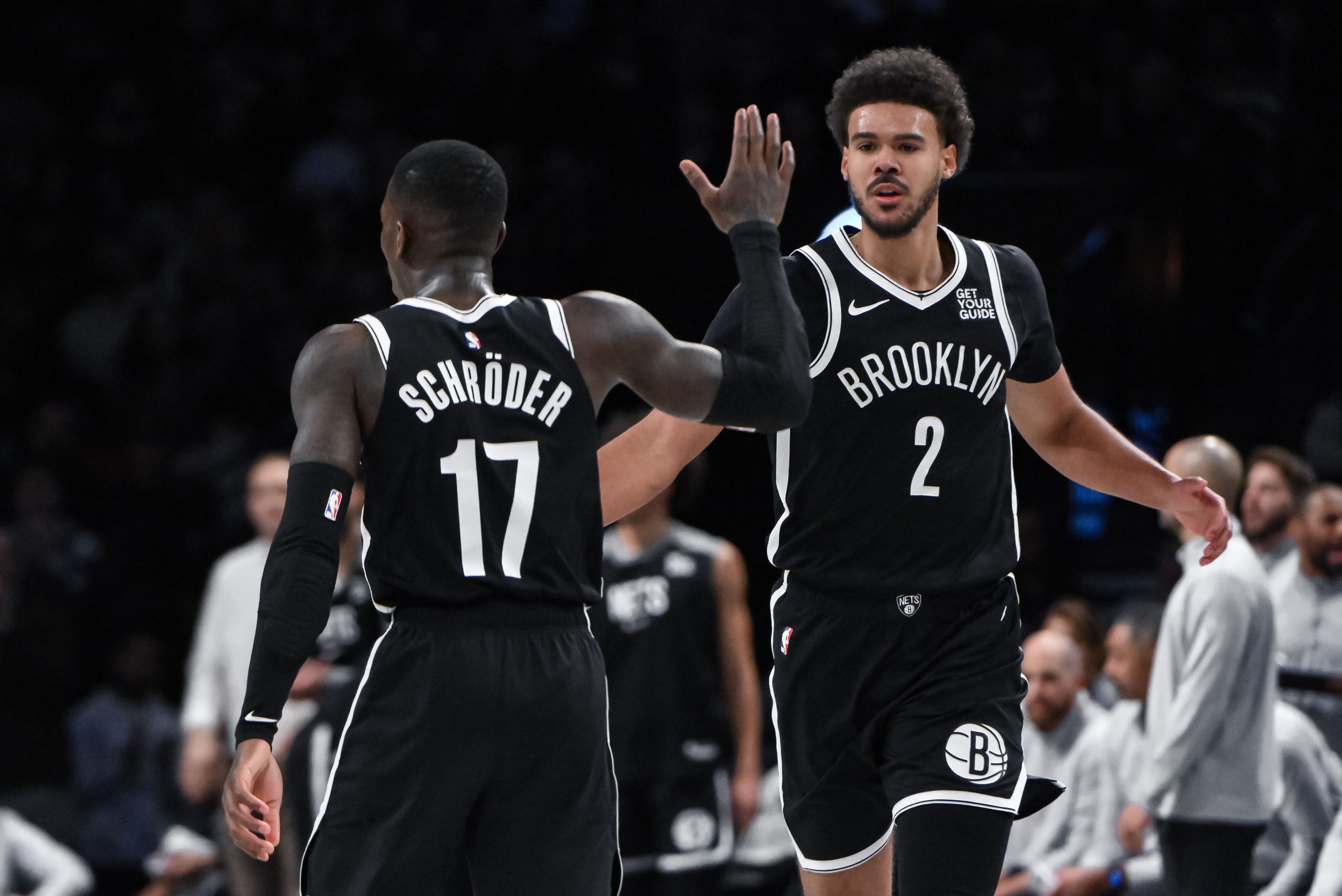 Brooklyn Nets forward Cameron Johnson and former Brooklyn Nets guard Dennis Schroder against the Milwaukee Bucks at Barclays Center. Photo Credit: Imagn