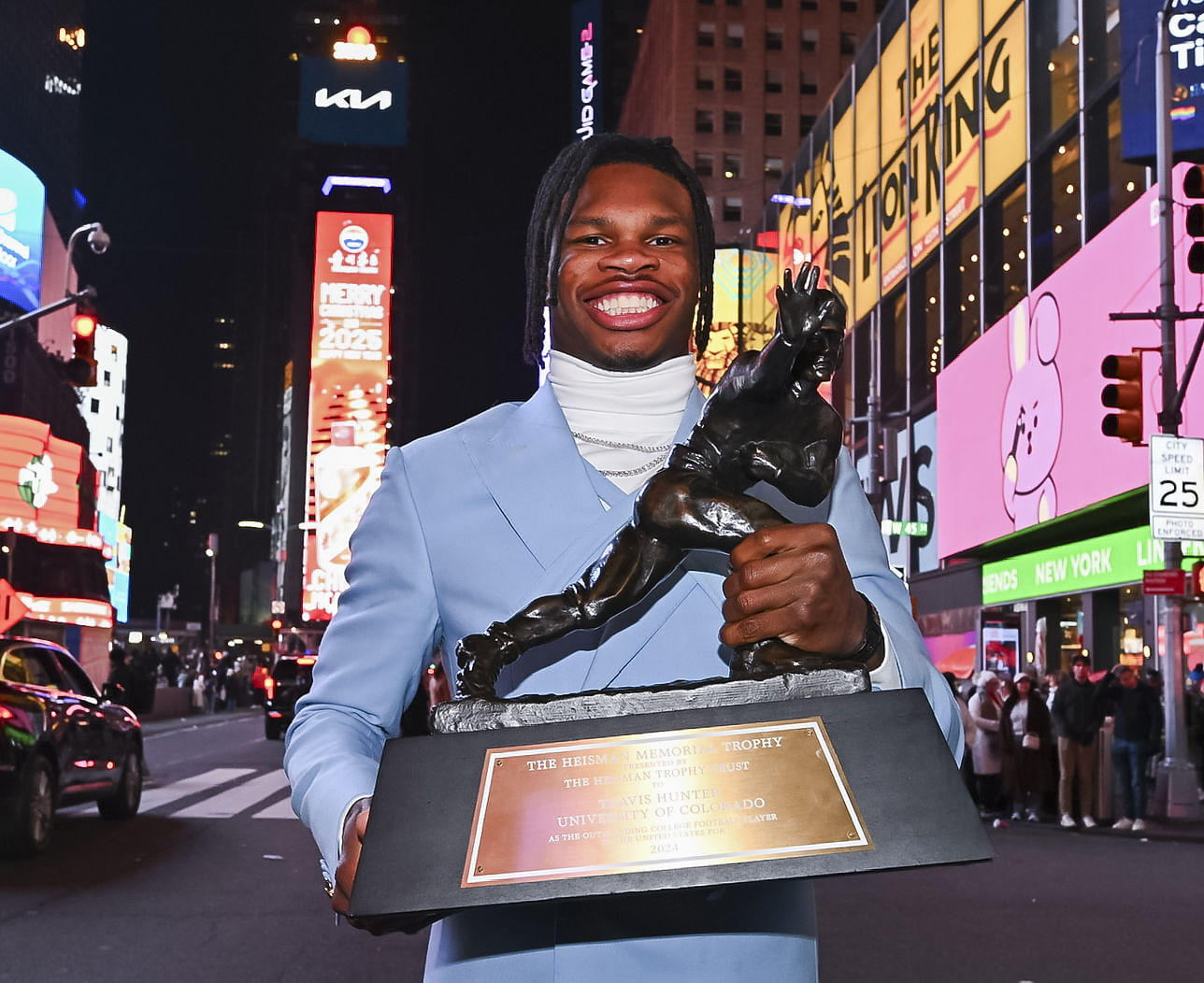 Travis Hunter with the Heisman Trophy - Source: Imagn