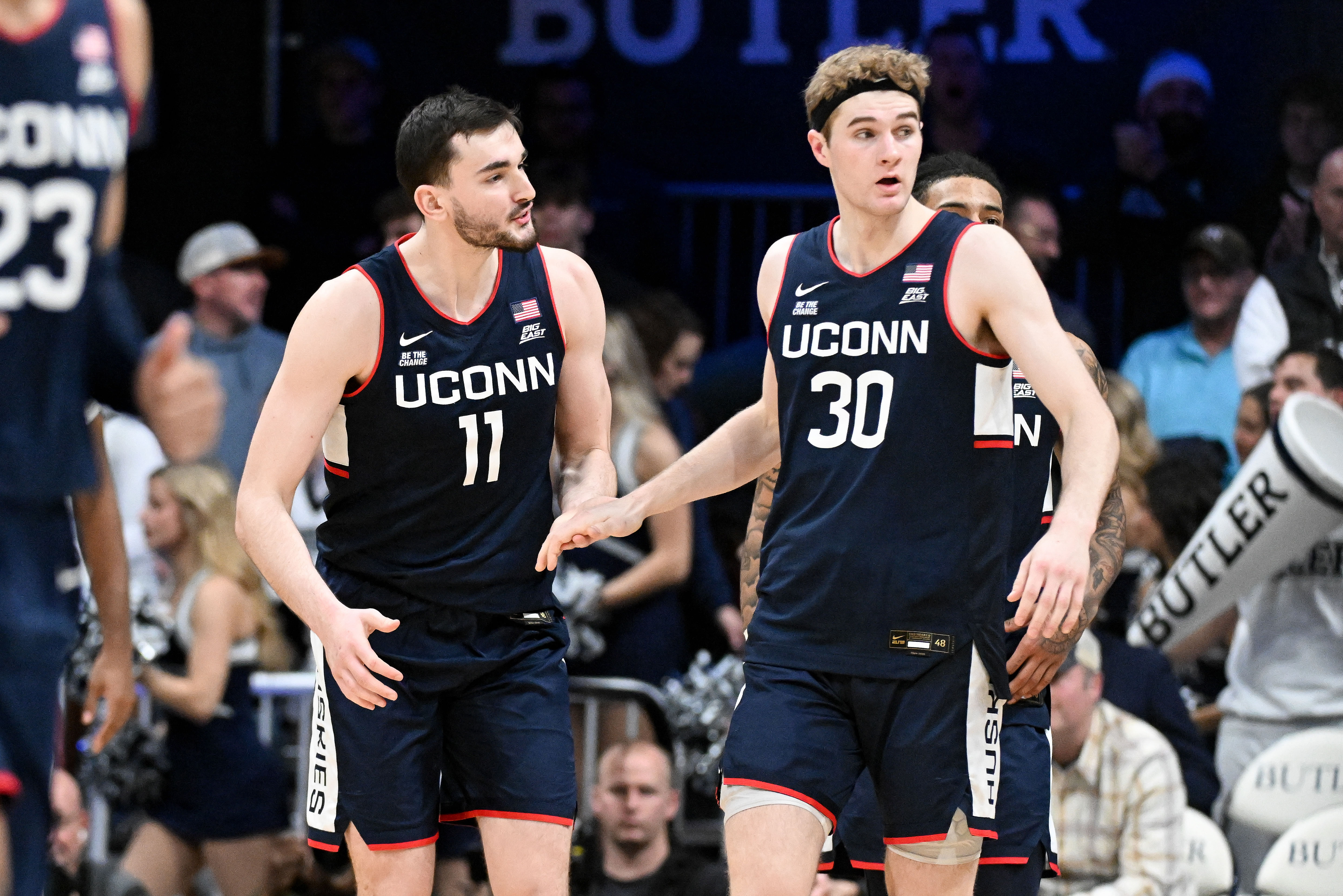 UConn Huskies forwards Alex Karaban (#11) and Liam McNeeley (#30) celebrate after defeating the Butler Bulldogs at Hinkle Fieldhouse. Photo: Imagn