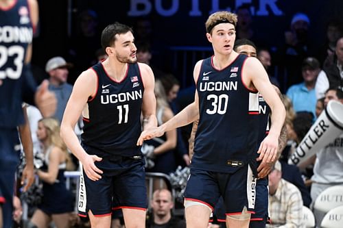 UConn Huskies forwards Alex Karaban (#11) and Liam McNeeley (#30) celebrate after defeating the Butler Bulldogs at Hinkle Fieldhouse. Photo: Imagn