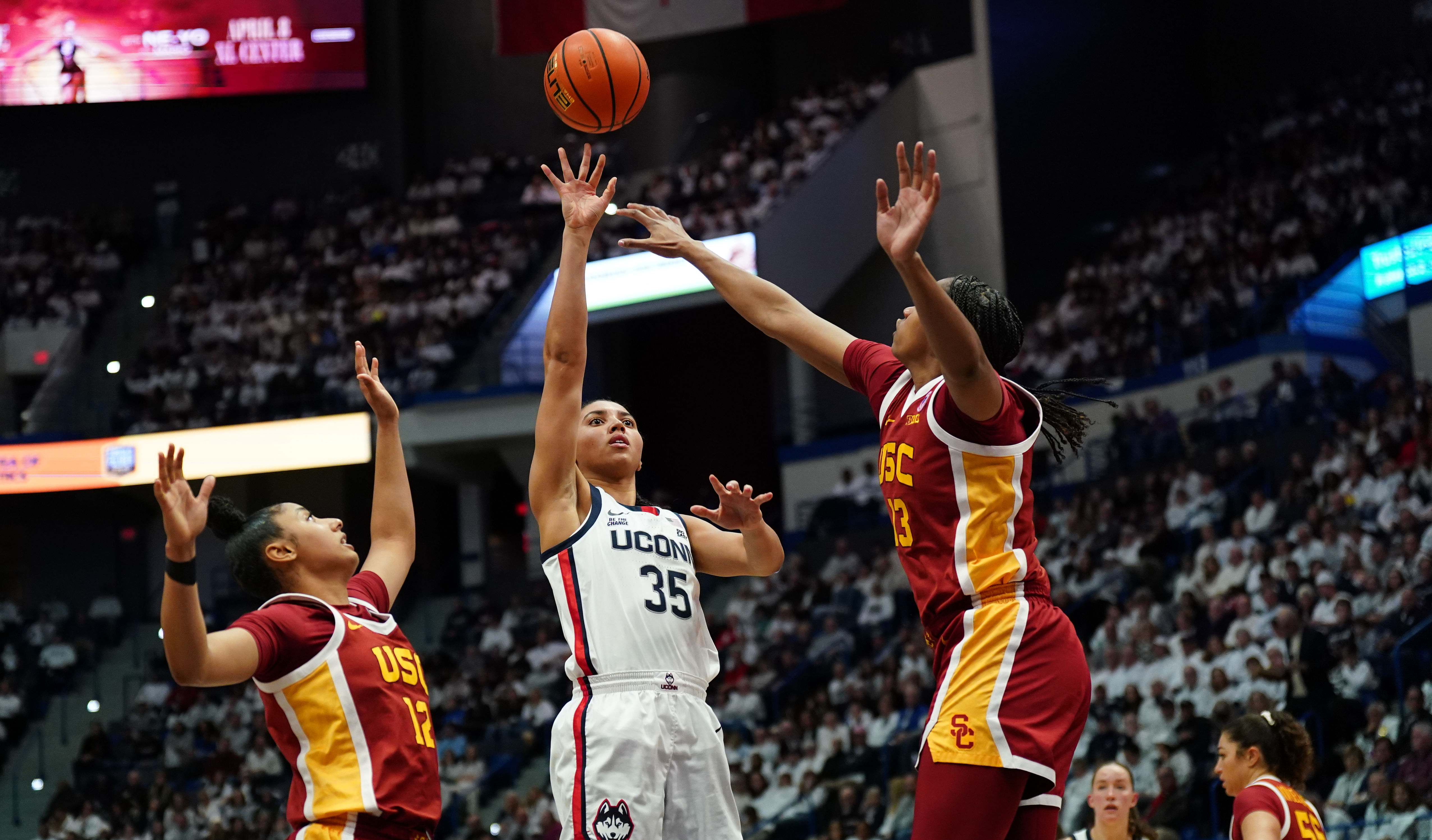 UConn Huskies guard Azzi Fudd (#35) shoots against USC Trojans guard JuJu Watkins (#12) and center Rayah Marshall (#13) in the first half of their NCAA game at XL Center. Photo: Imagn