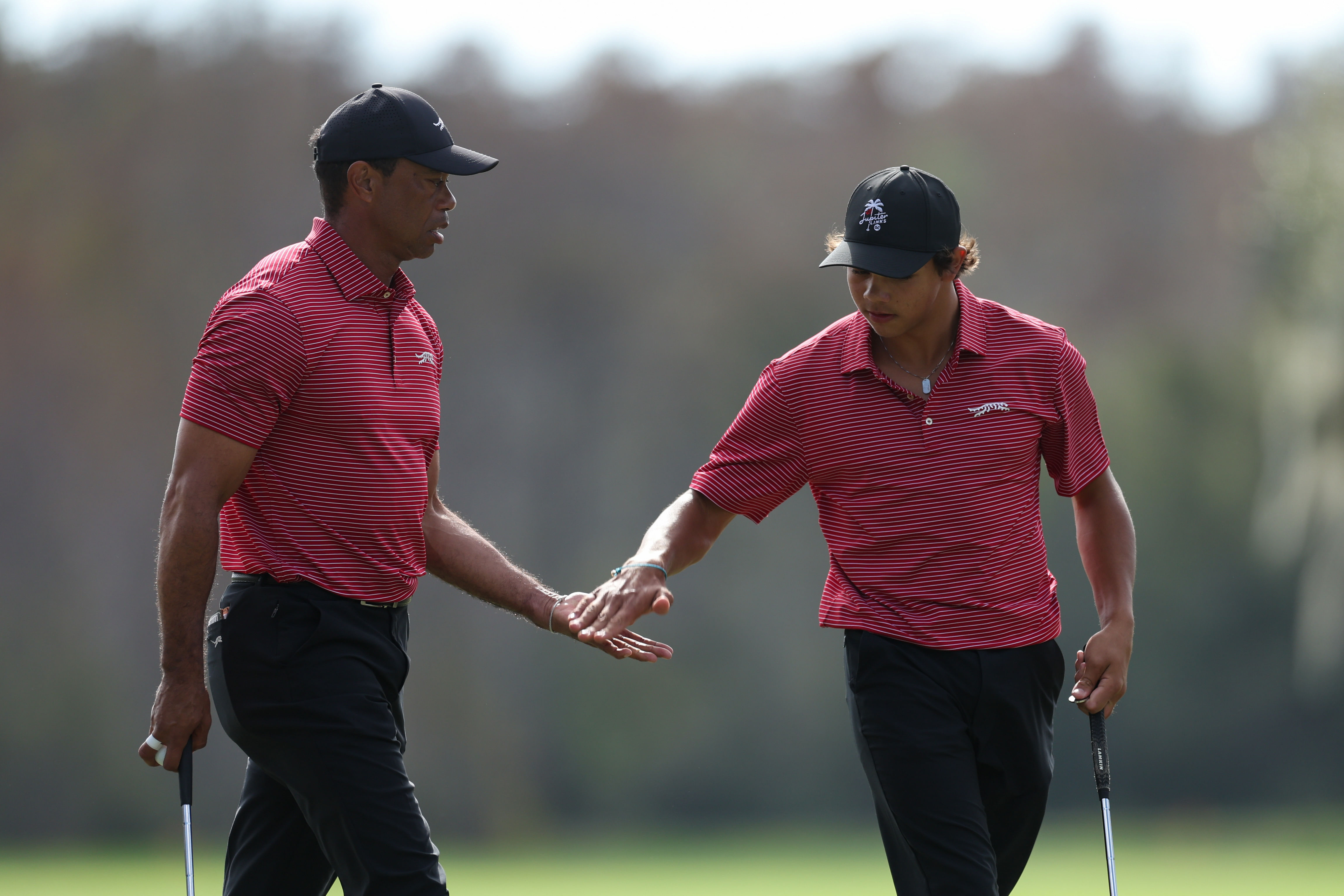 Tiger Woods and son Charlie Woods celebrate after a putt on the ninth green during the PNC Championship (Image Source: Imagn)