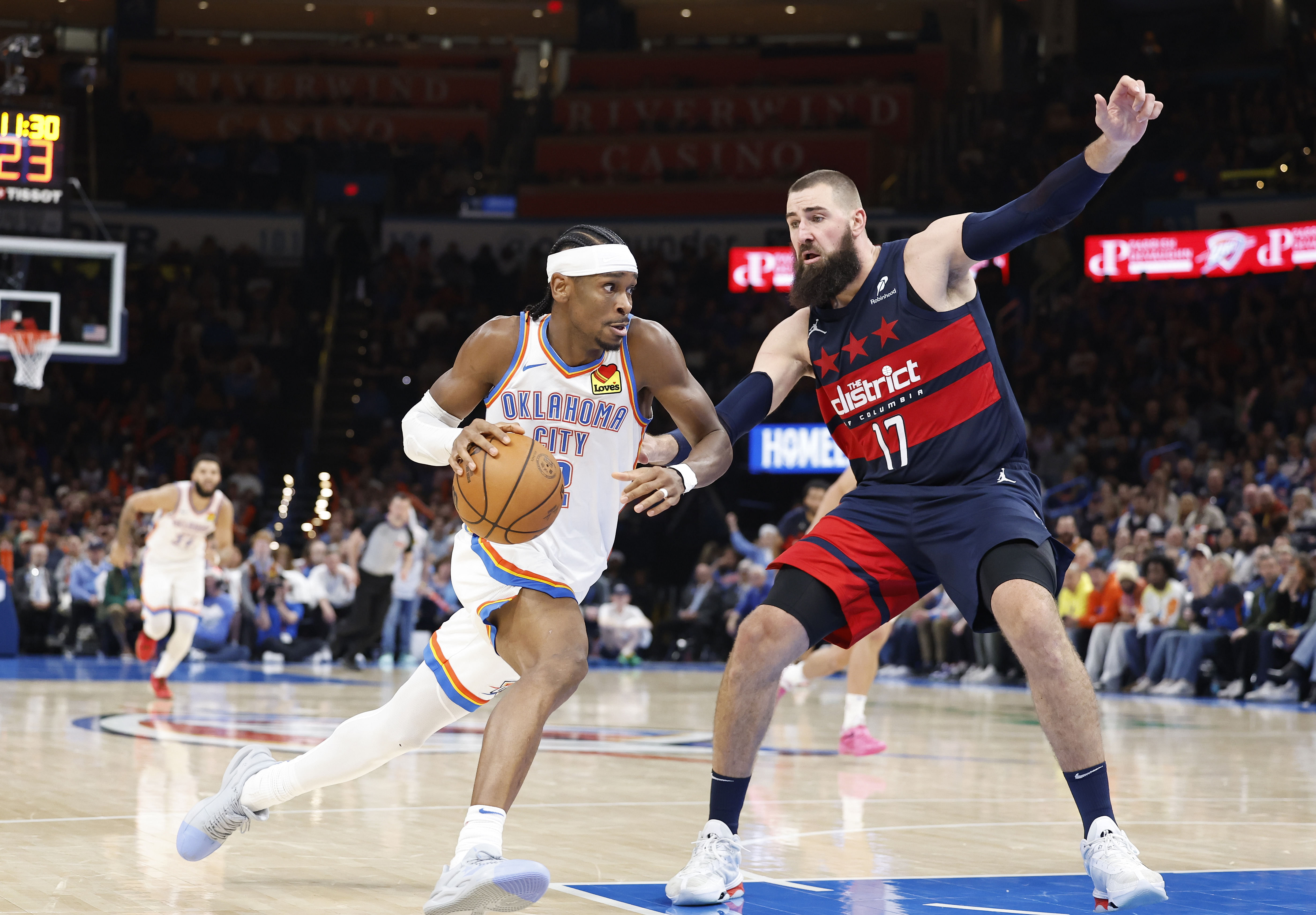 Oklahoma City Thunder guard Shai Gilgeous-Alexander (2) drives to the basket as Washington Wizards center Jonas Valanciunas defends at Paycom Center. Photo Credit: Imagn