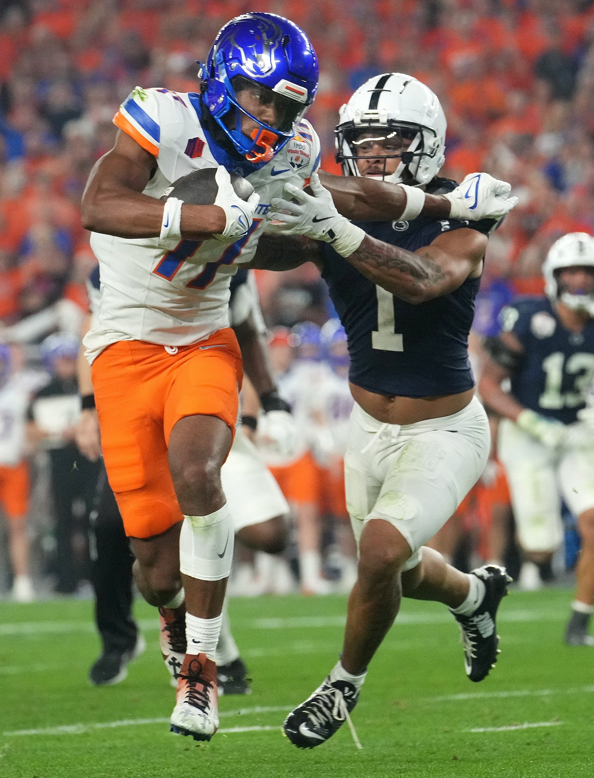 Boise State Broncos receiver Prince Strachan (17) tries to break away from Penn State Nittany Lions safety Jaylen Reed (1) during their Vrbo Fiesta Bowl matchup - Source: Imagn