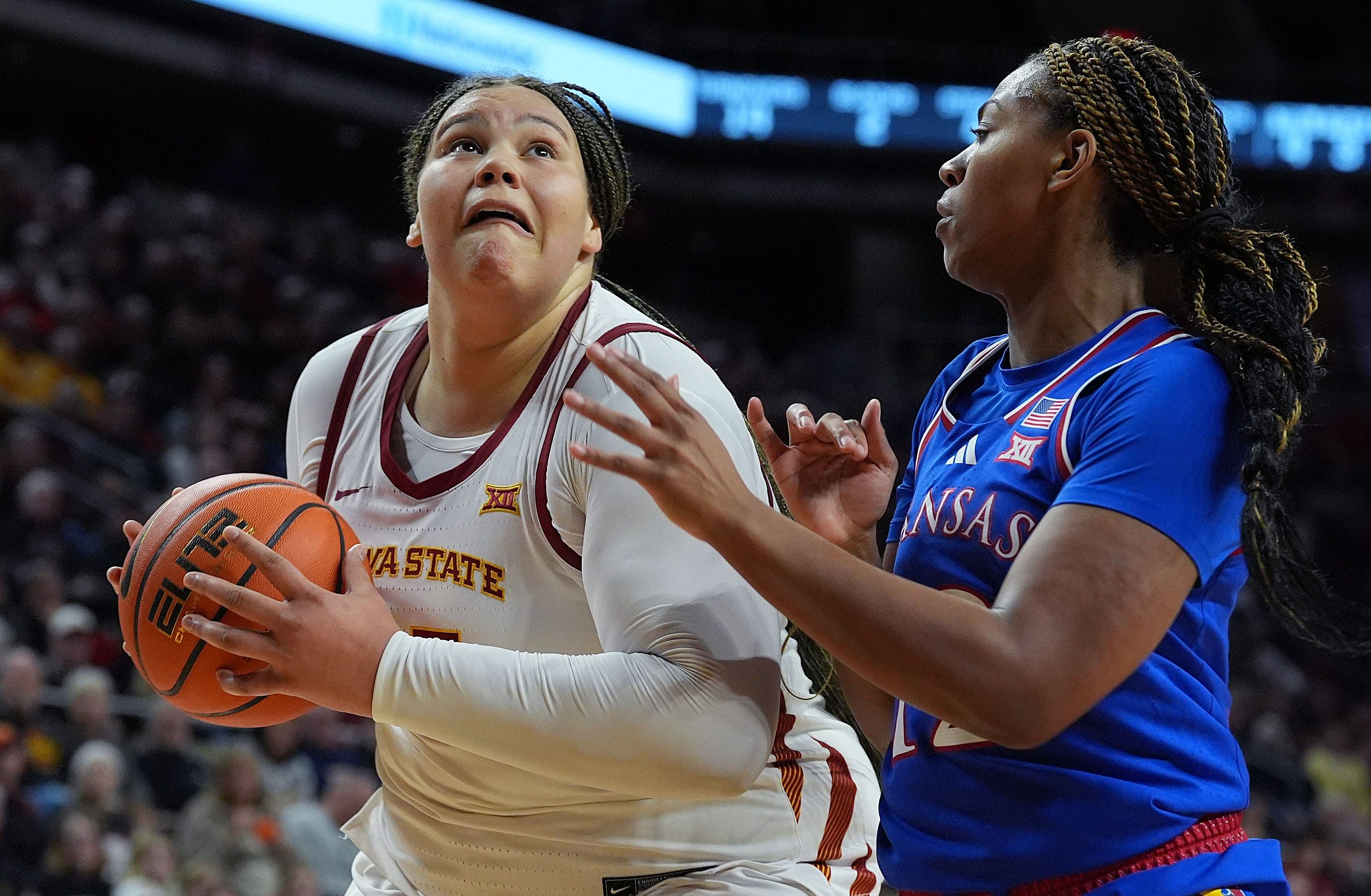 Iowa State Cyclones center Audi Crooks (#55) drives to the basket around Kansas Jayhawks guard S&#039;Mya Nichols (#12) during the fourth quarter of their Big 12 clash at Hilton Coliseum on Wednesday, Jan. 1, 2025. Photo: Imagn