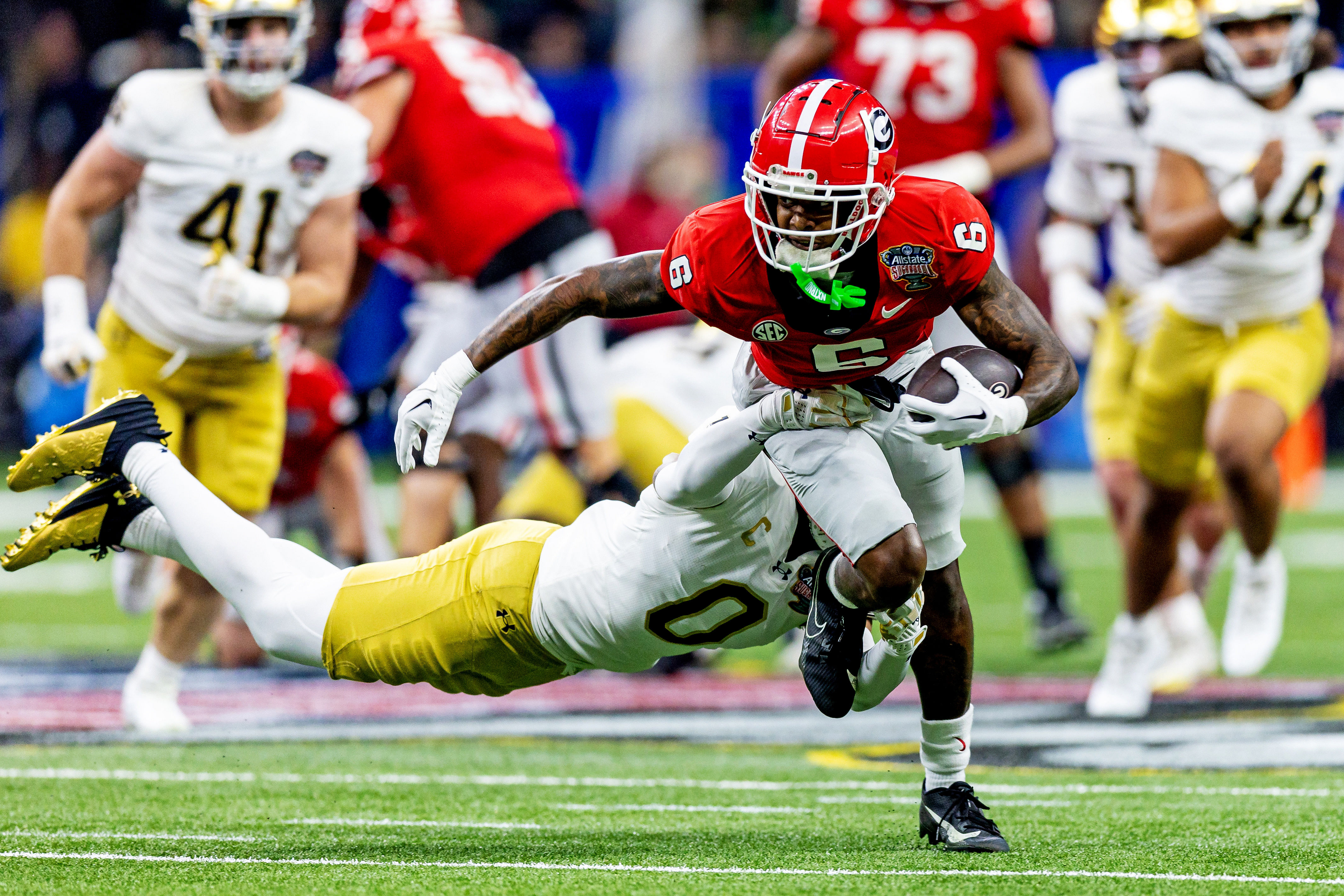 Georgia Bulldogs wide receiver Dominic Lovett (6) runs the ball as Notre Dame Fighting Irish safety Xavier Watts (0) attempts a tackle during the second quarter of the Sugar Bowl - Source: Imagn