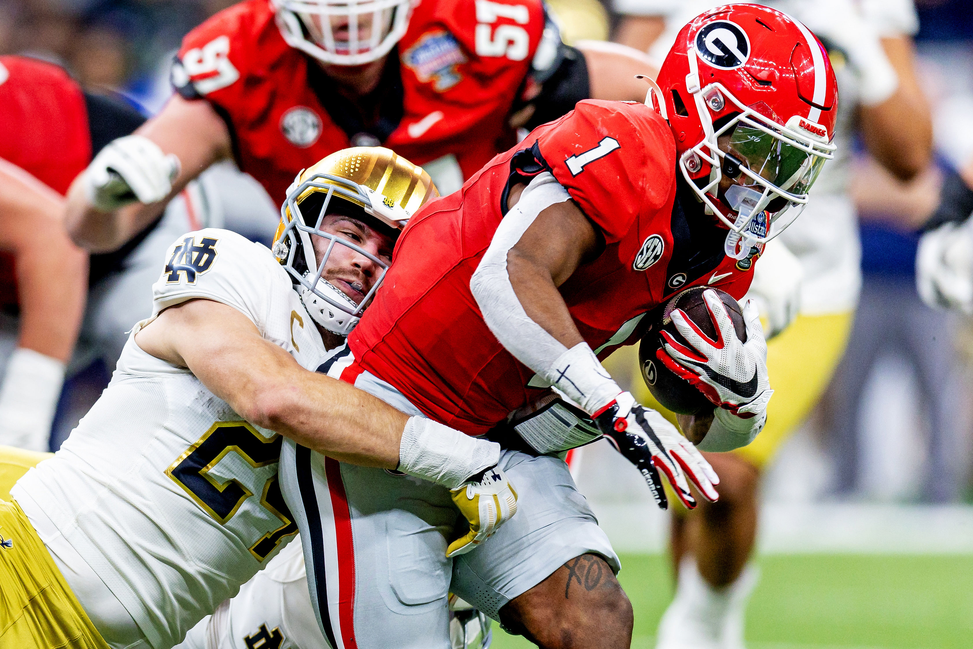 Georgia Bulldogs defensive back Ellis Robinson IV (1) is tackled by Notre Dame Fighting Irish linebacker Jack Kiser (24) during the second quarter of the Sugar Bowl - Source: Imagn