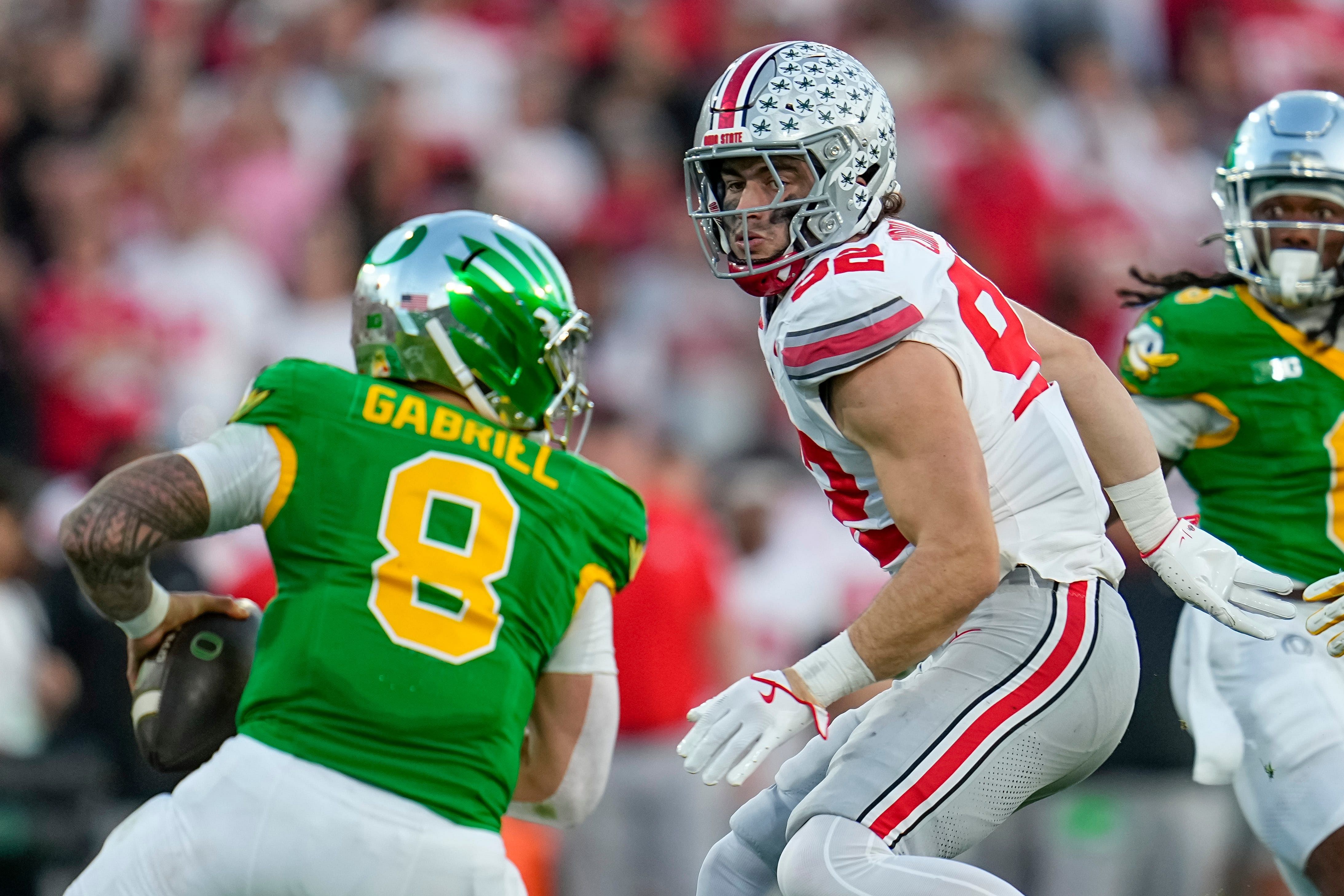 Ohio State Buckeyes defensive end Caden Curry (92) pursues Oregon Ducks quarterback Dillon Gabriel (8) in their Rose Bowl game. (Credits: IMAGN)