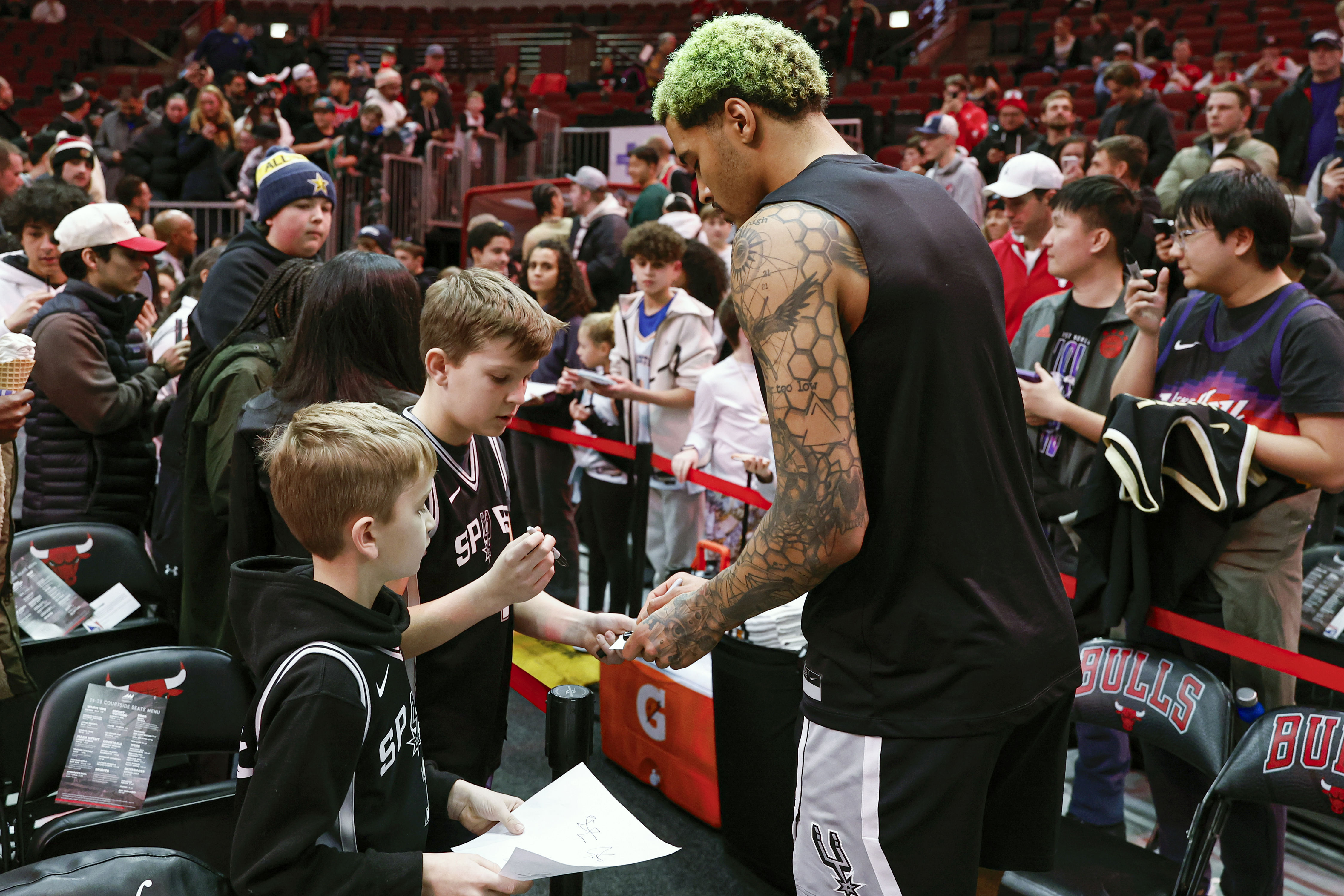 Jan 6, 2025; Chicago, Illinois, USA; San Antonio Spurs forward Jeremy Sochan (10) signs autographs before a game against the Chicago Bulls at United Center. Mandatory Credit: Kamil Krzaczynski-Imagn Images - Source: Imagn